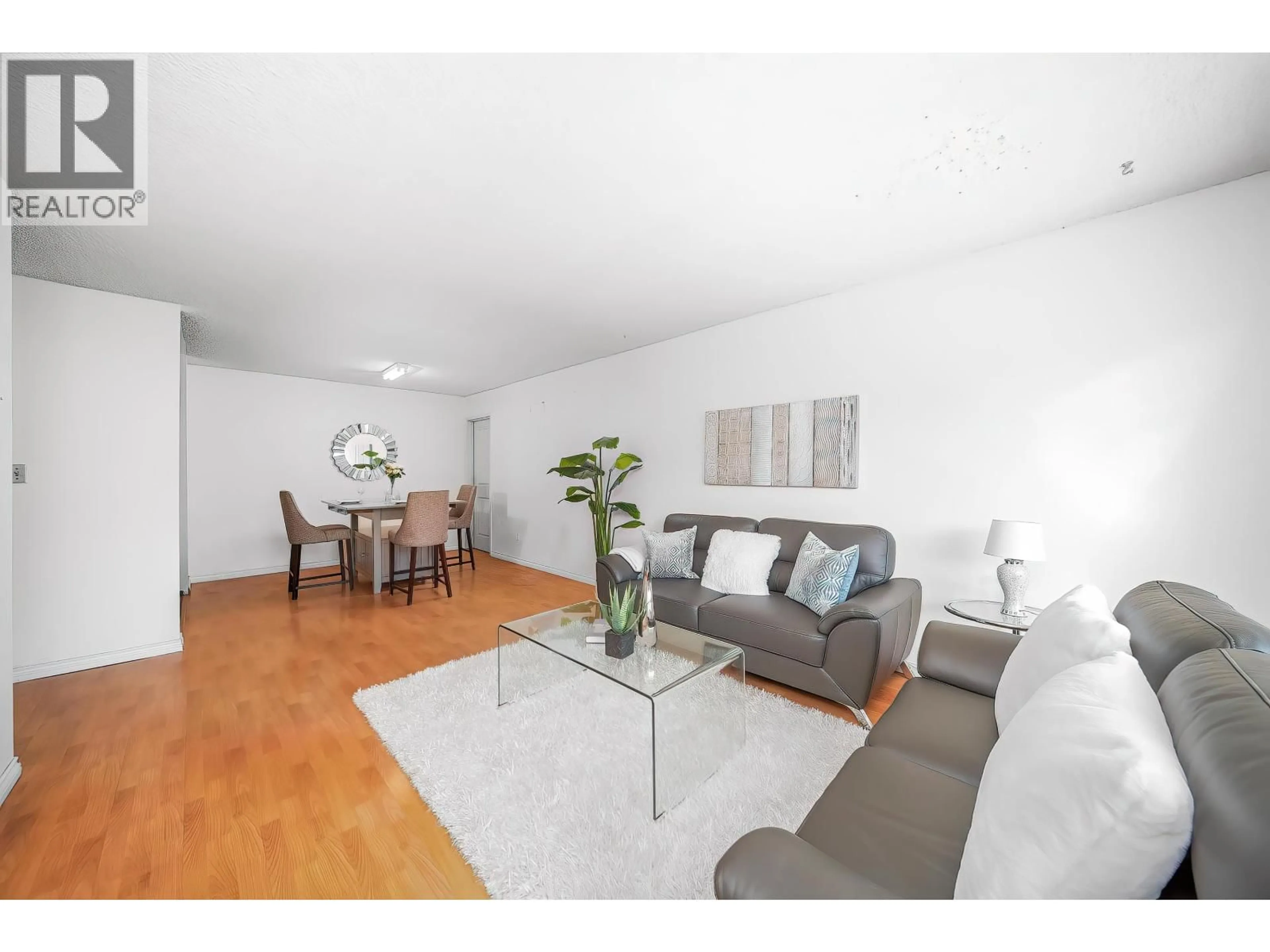 Living room with furniture, wood/laminate floor for 211 - 8700 ACKROYD ROAD, Richmond British Columbia V6X3G2