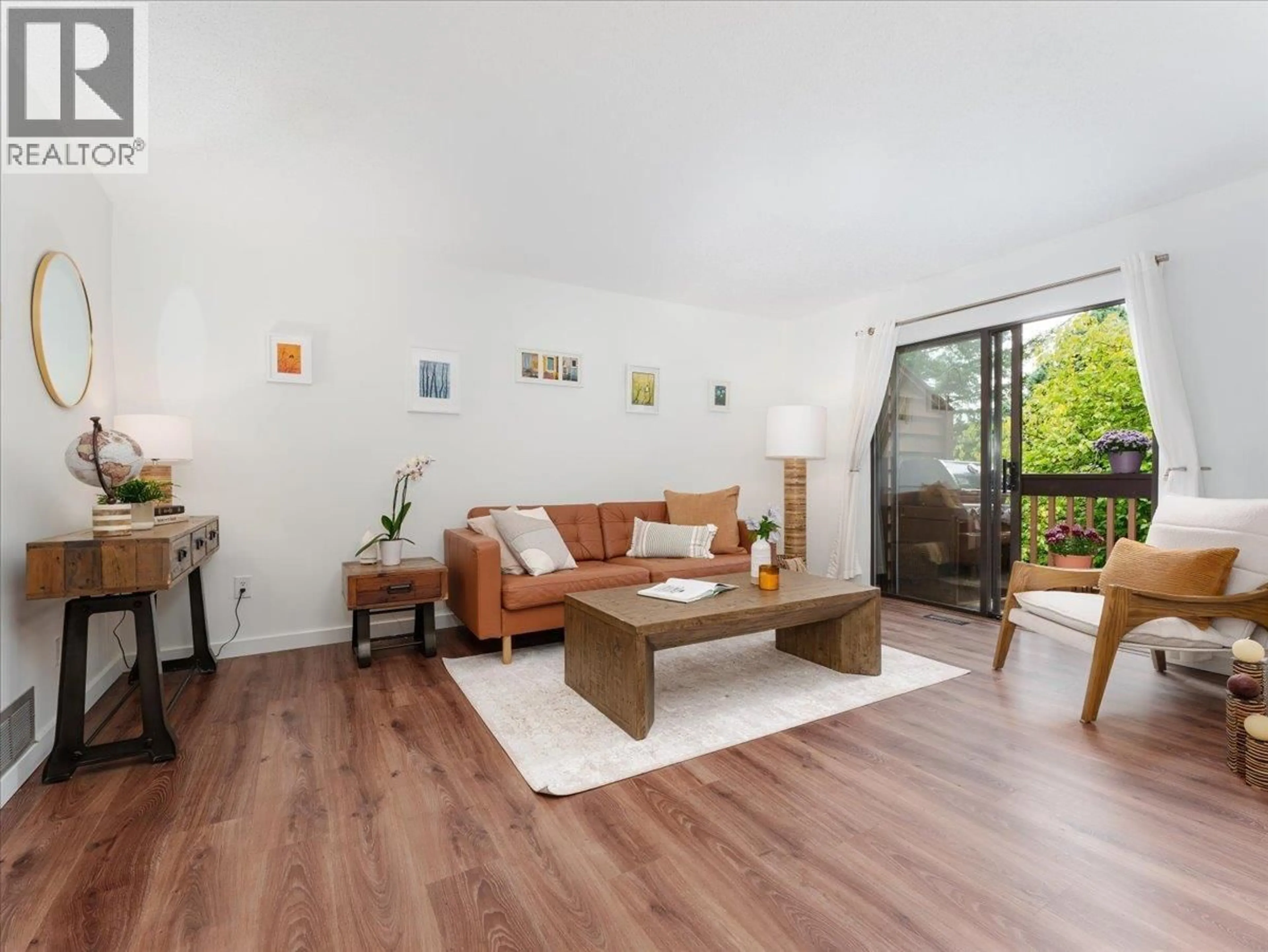 Living room with furniture, wood/laminate floor for 402 CARDIFF WAY, Port Moody British Columbia V3H3T1