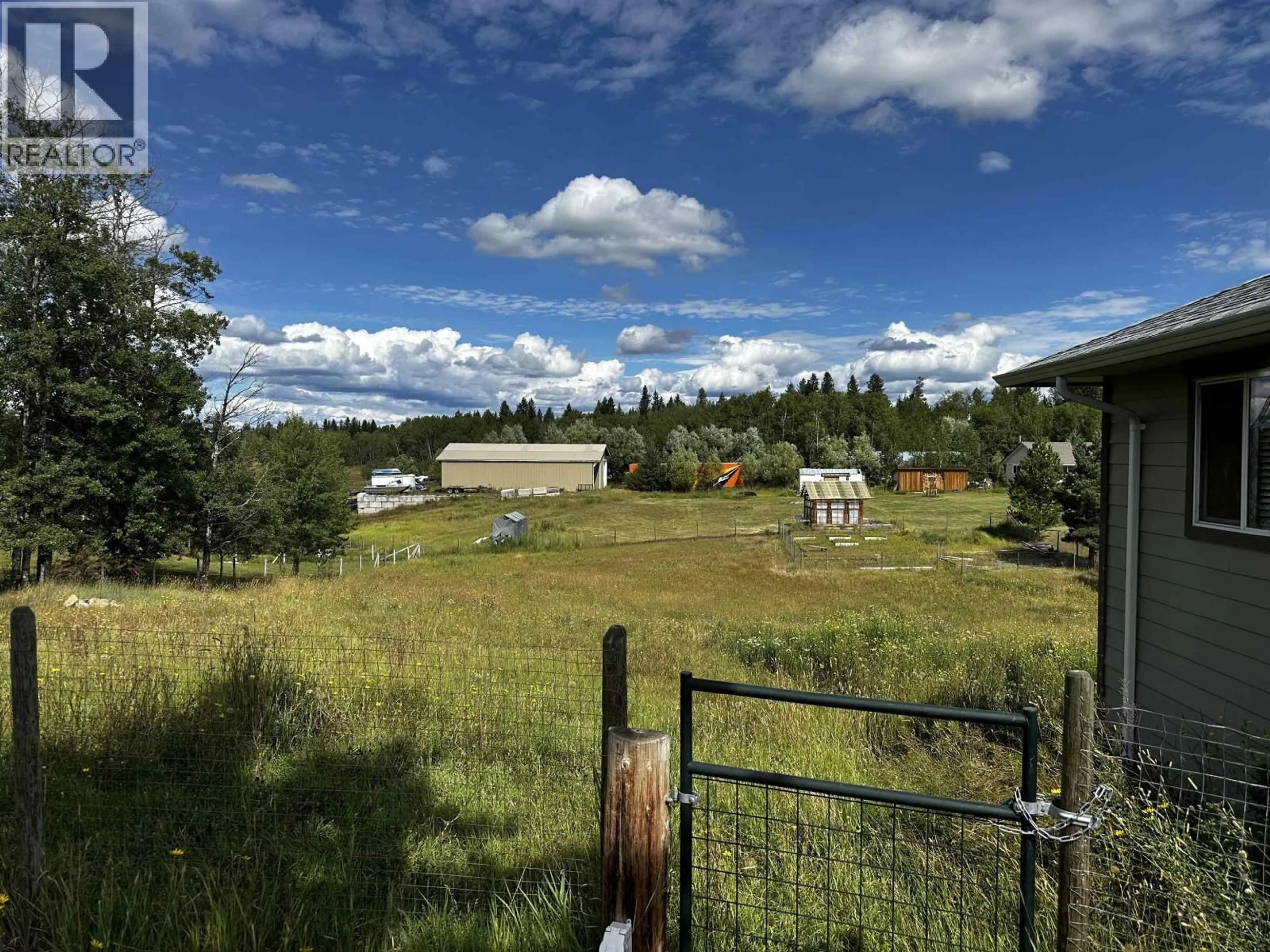 A pic from outside/outdoor area/front of a property/back of a property/a pic from drone, mountain view for 5553 PARK DRIVE, 103 Mile House British Columbia V0K2E1