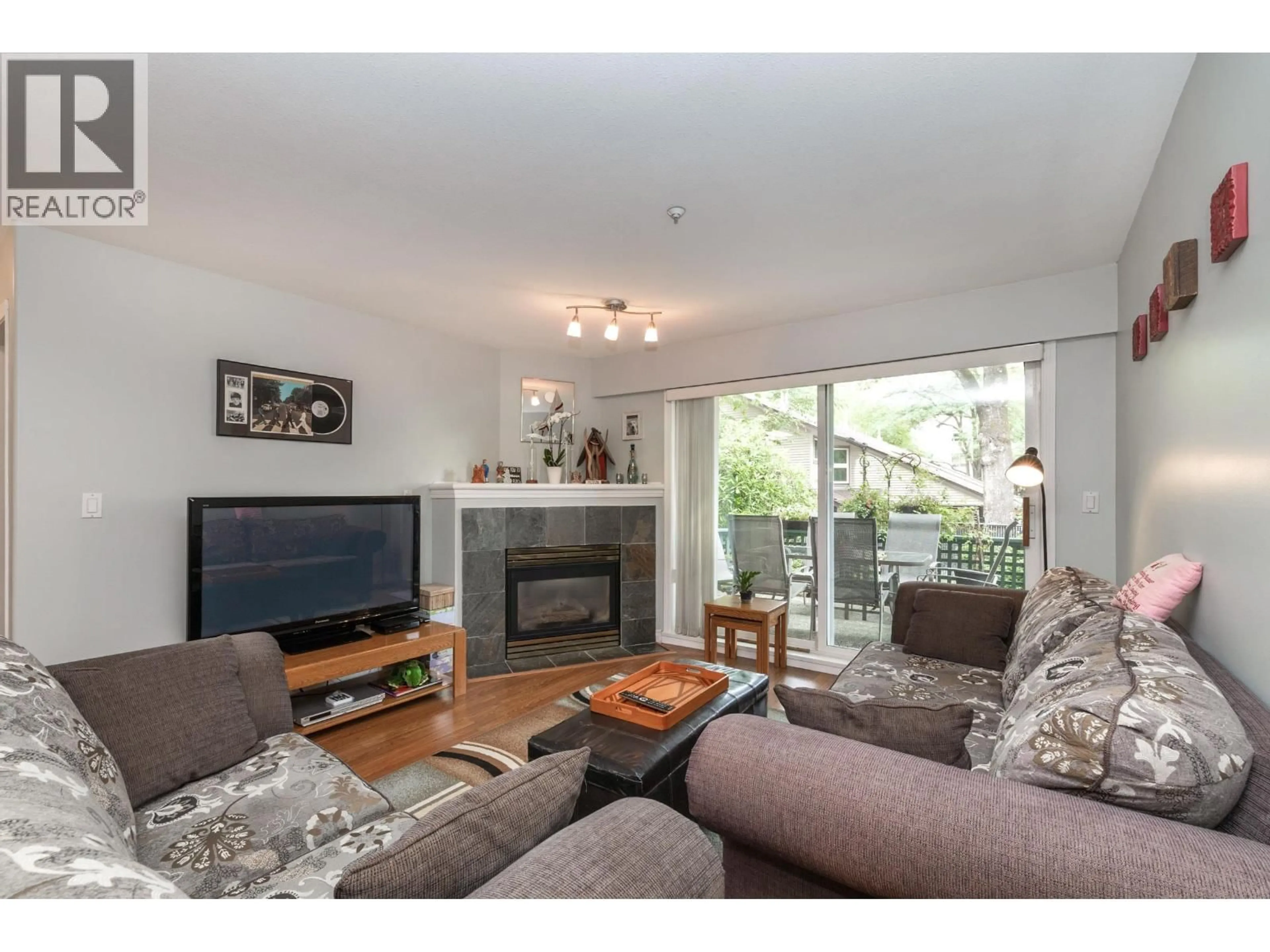 Living room with furniture, wood/laminate floor for 103 - 11960 HARRIS ROAD, Pitt Meadows British Columbia V3Y2R1