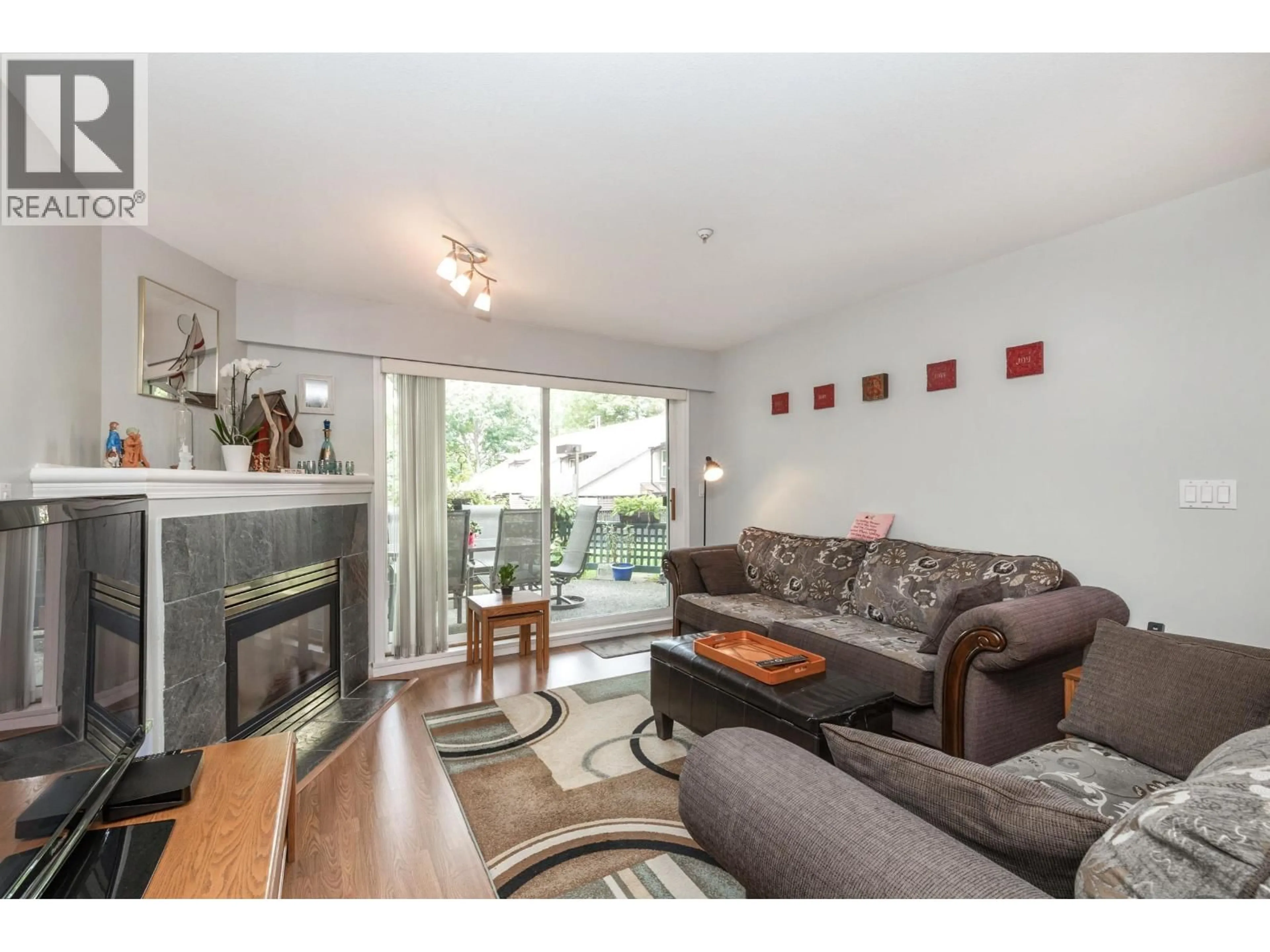 Living room with furniture, wood/laminate floor for 103 - 11960 HARRIS ROAD, Pitt Meadows British Columbia V3Y2R1
