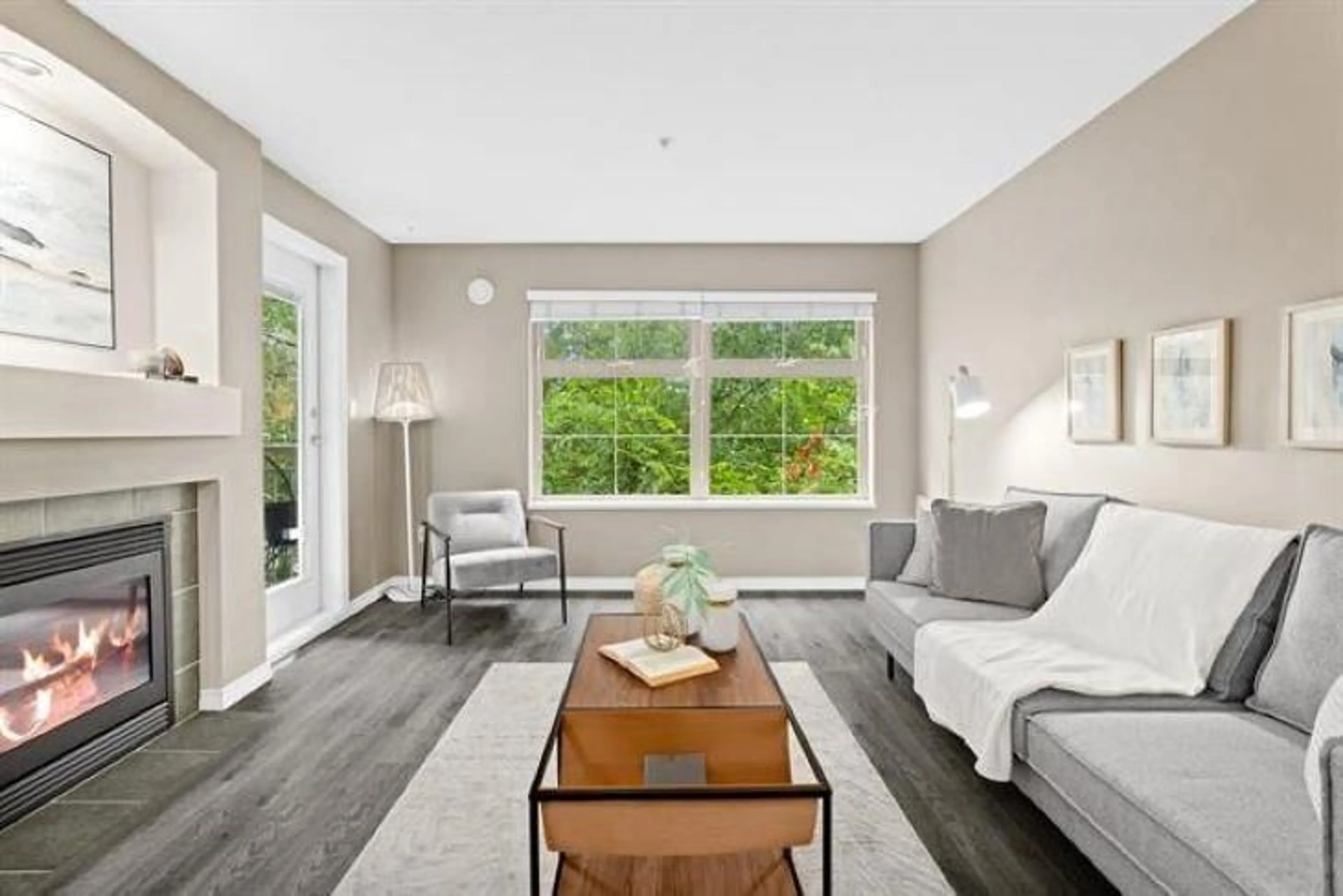 Living room with furniture, wood/laminate floor for 307 - 10088 148, Surrey British Columbia V3R3M9