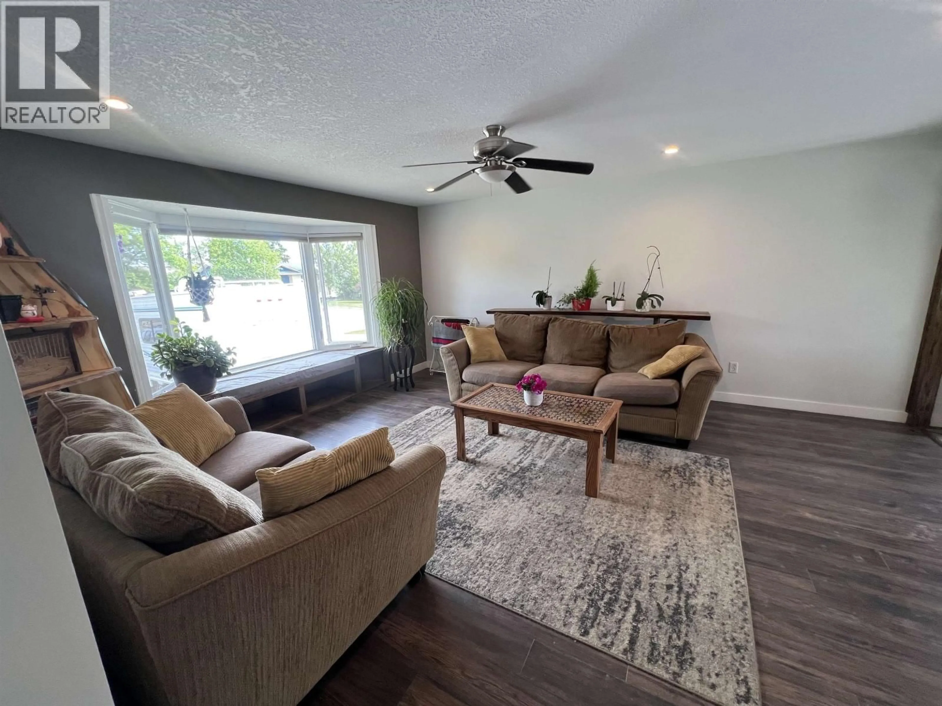 Living room with furniture, wood/laminate floor for 8604 78A STREET, Fort St. John British Columbia V1J3B1