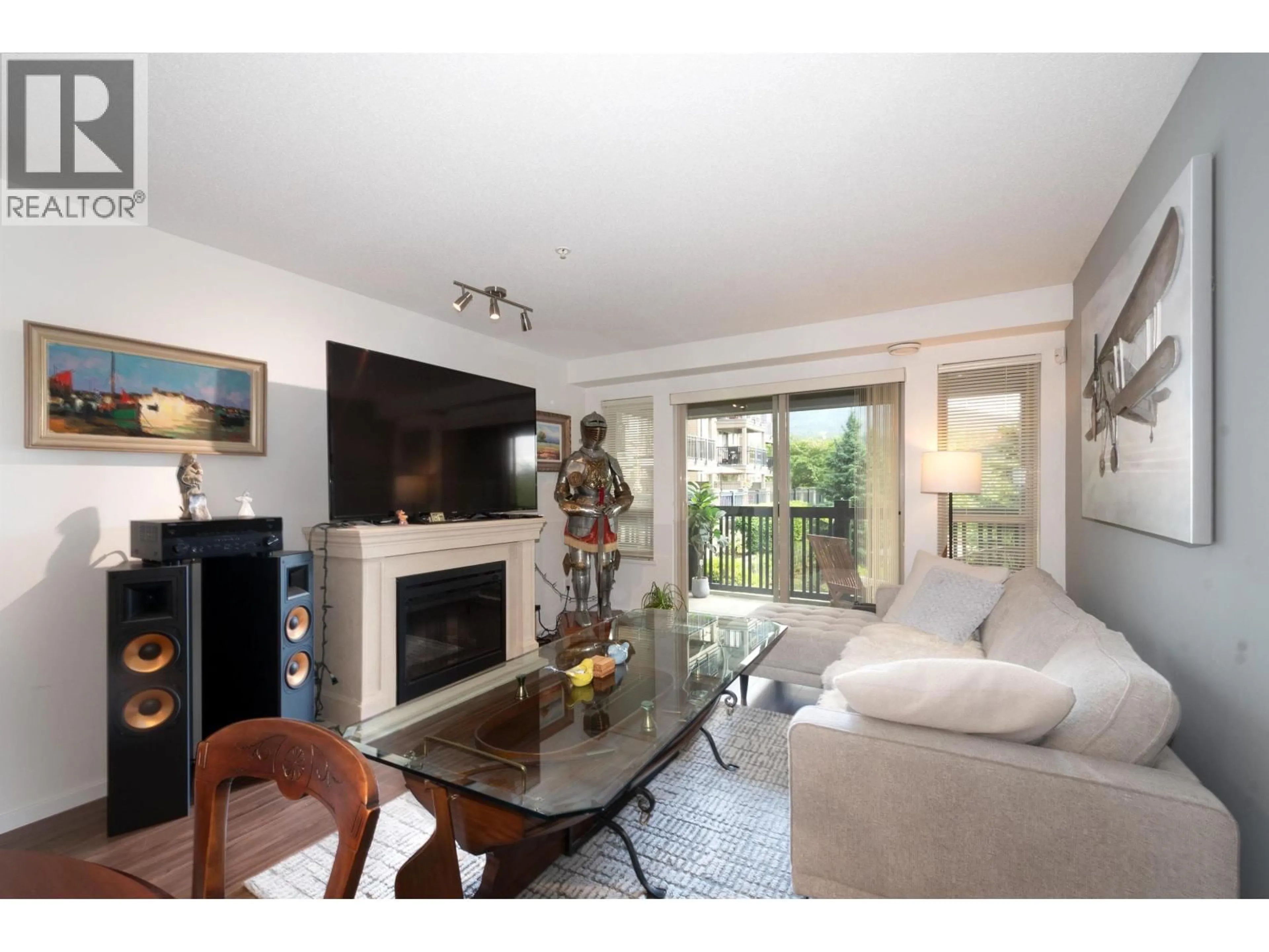 Living room with furniture, wood/laminate floor for 211 - 3178 DAYANEE SPRINGS BOULEVARD, Coquitlam British Columbia V3E0B9