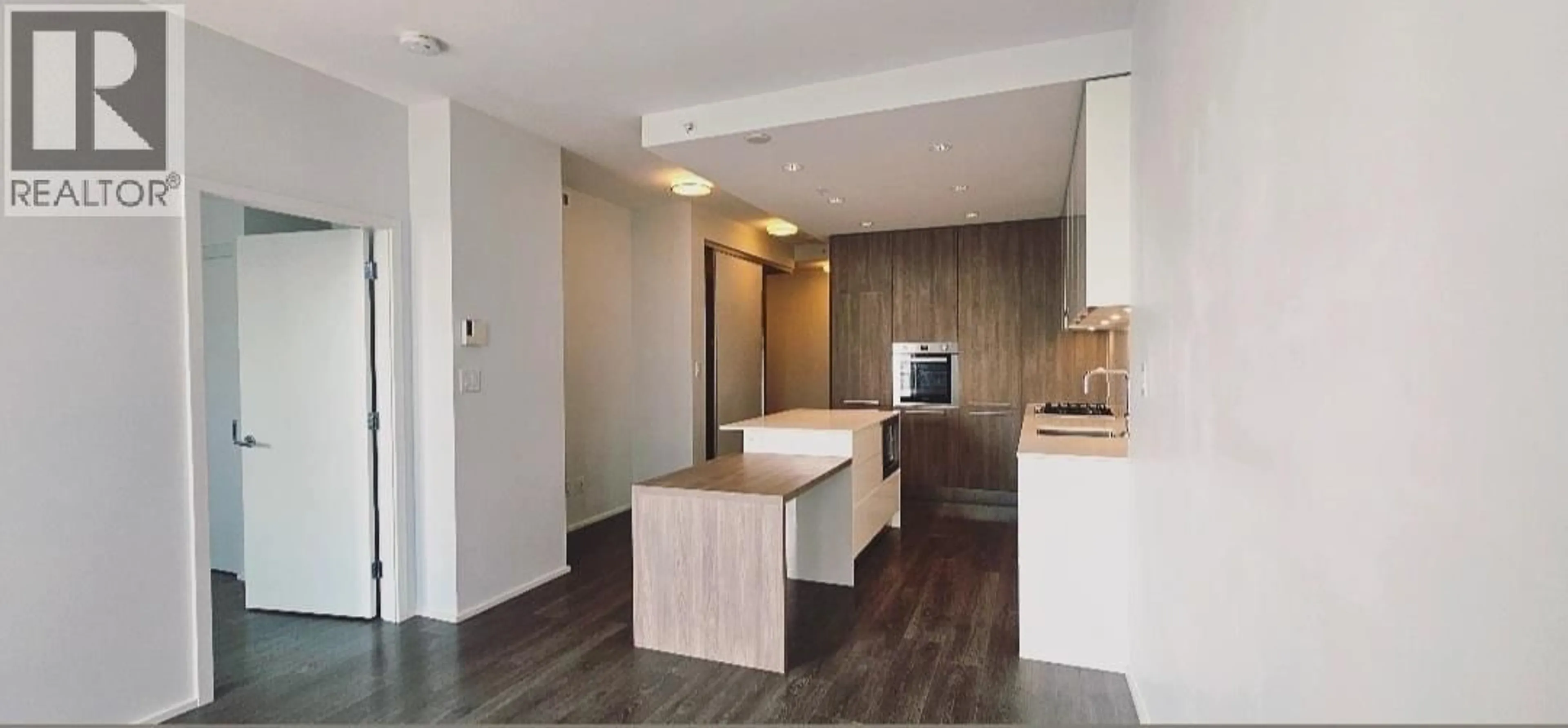 Open concept kitchen, wood/laminate floor for 4601 - 1955 ALPHA WAY, Burnaby British Columbia V5C0K6