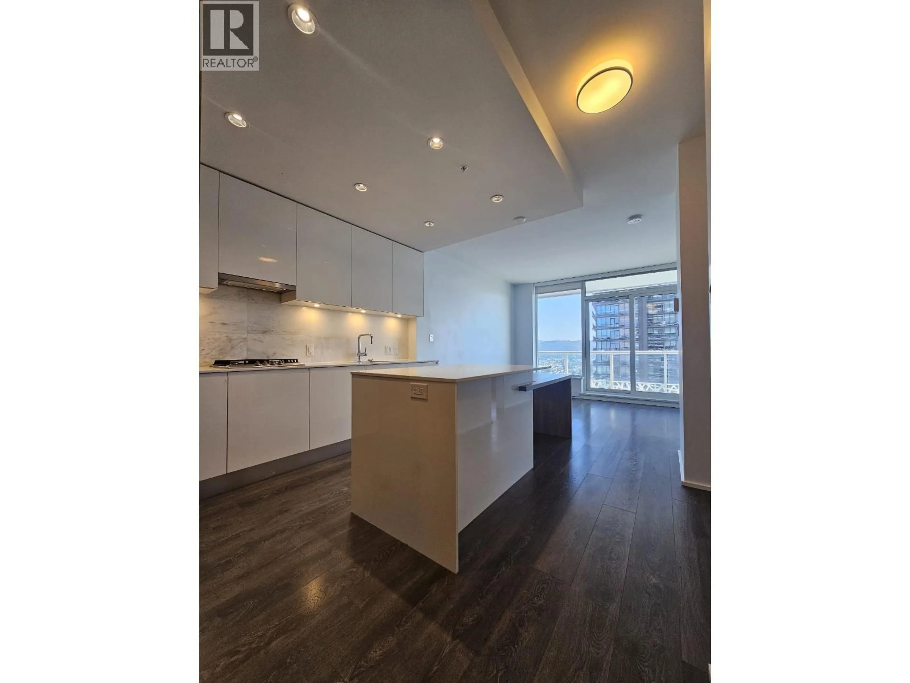 Open concept kitchen, wood/laminate floor for 4601 - 1955 ALPHA WAY, Burnaby British Columbia V5C0K6