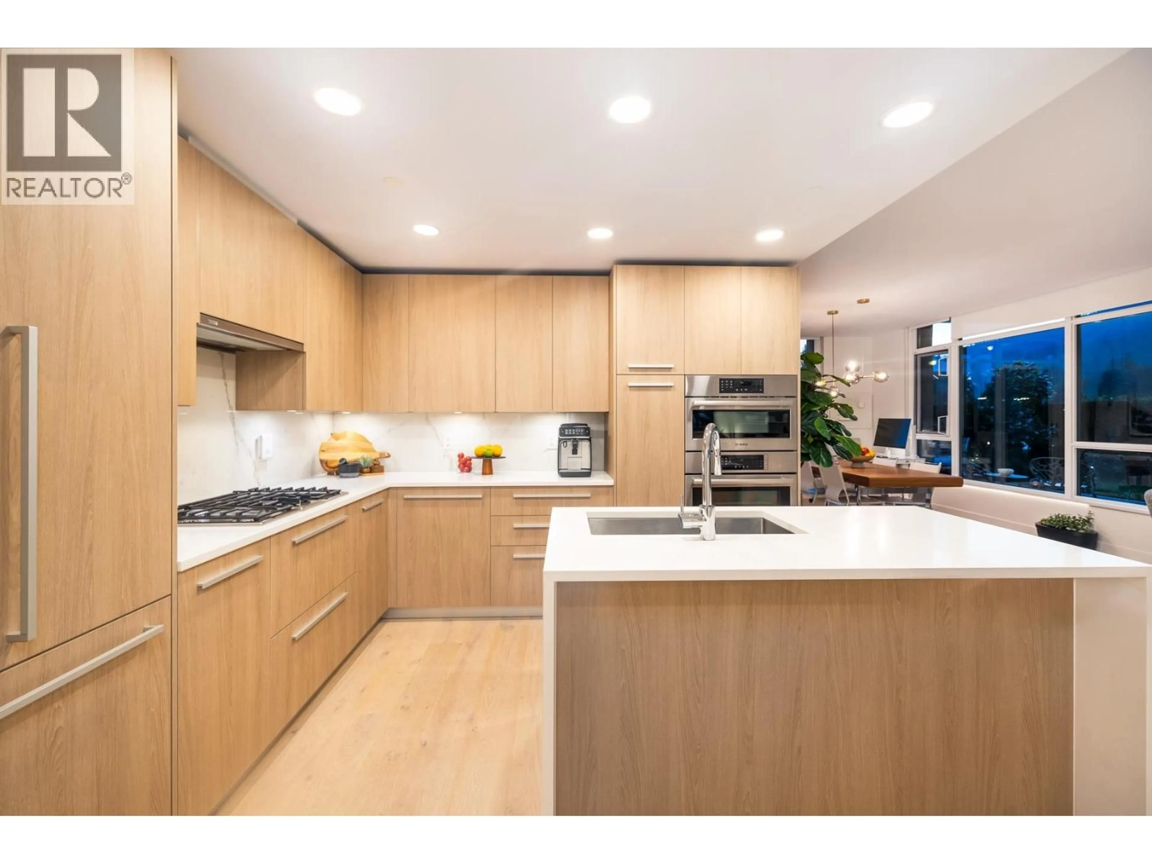 Contemporary kitchen, wood/laminate floor for 205 - 2780 VALLEY CENTRE AVENUE, North Vancouver British Columbia V7J0C4
