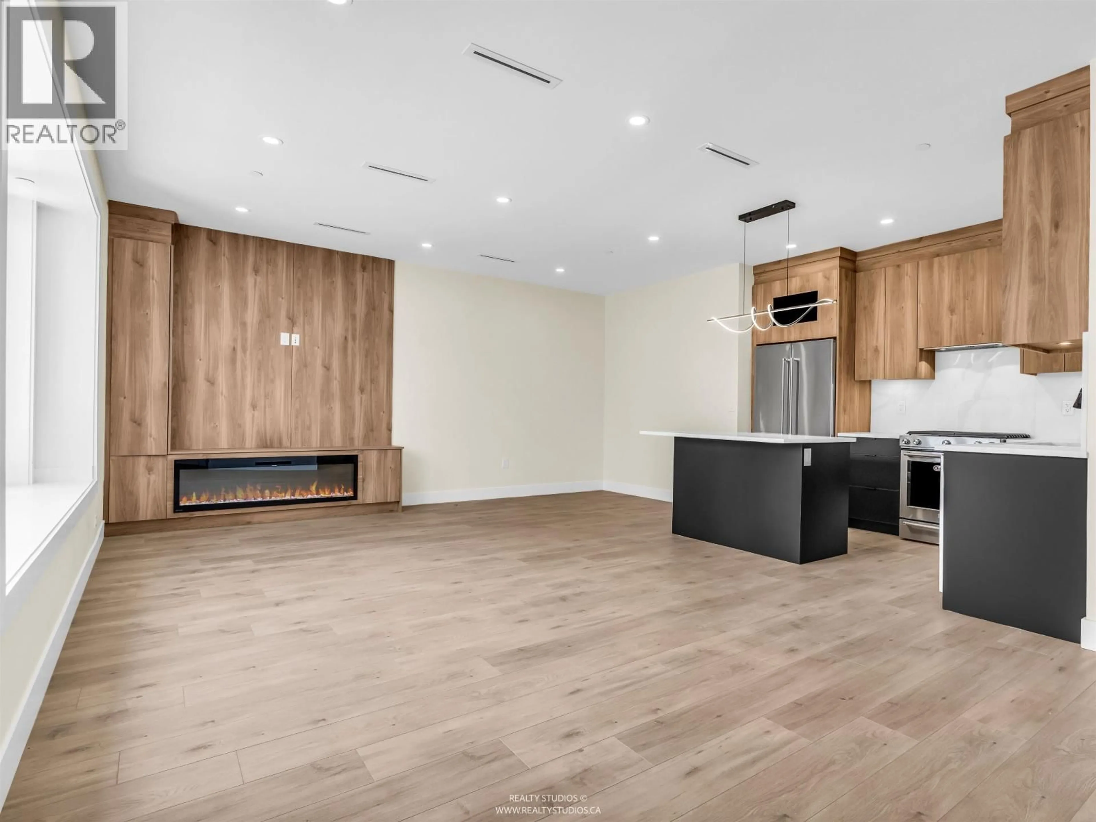 Open concept kitchen, wood/laminate floor for 1 - 5221 CLARENDON STREET, Vancouver British Columbia V5R3J7