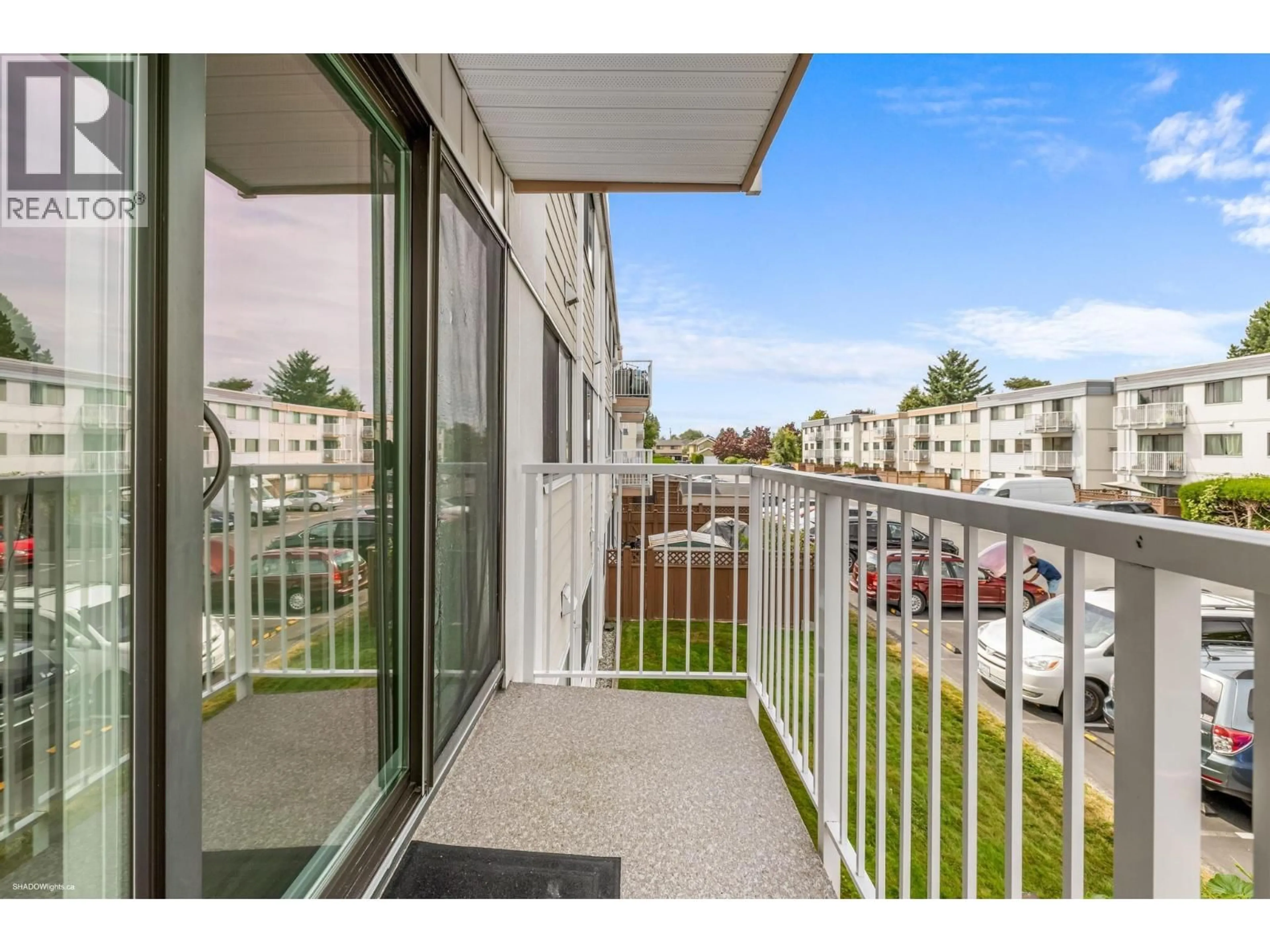 Balcony in the apartment, city buildings view from balcony for 211 - 7260 LINDSAY ROAD, Richmond British Columbia V7C3M6