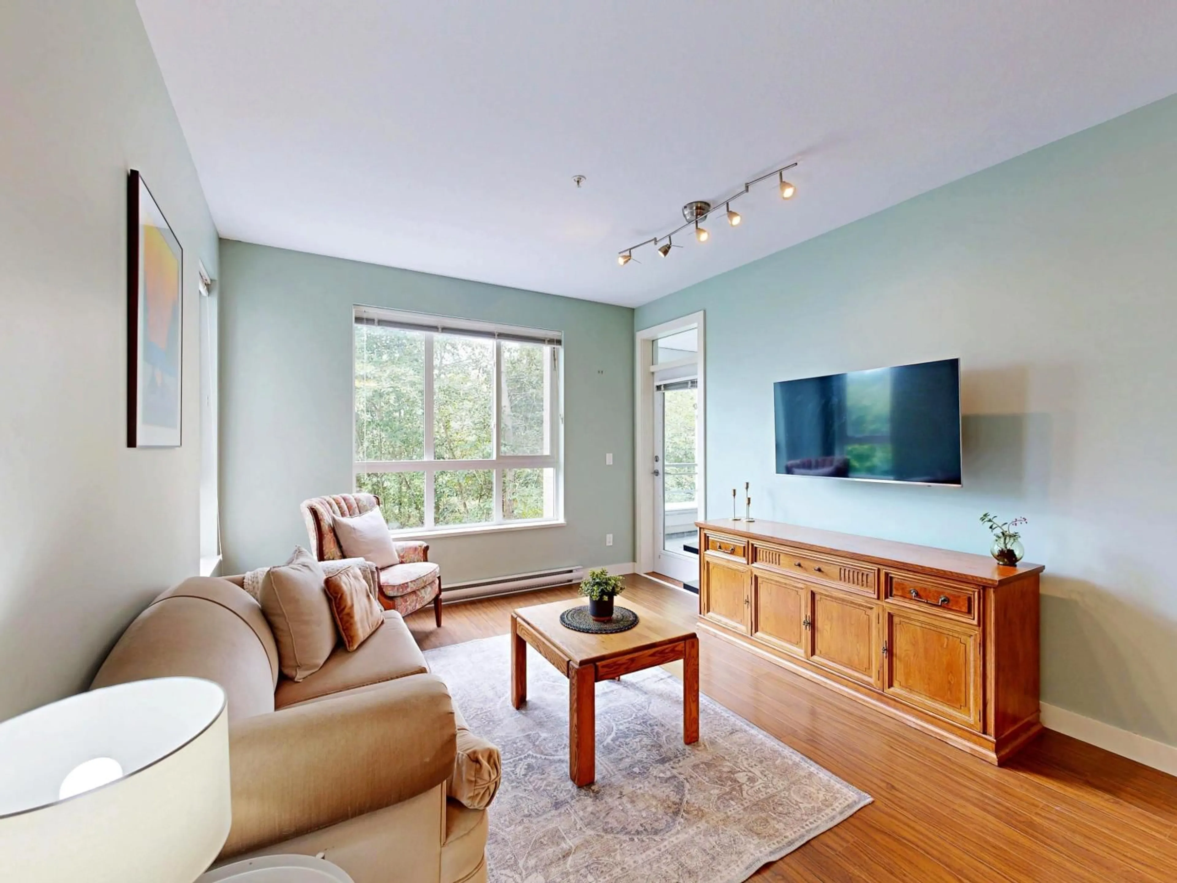 Living room with furniture, wood/laminate floor for 213 - 15428 31, Surrey British Columbia V3Z3W4