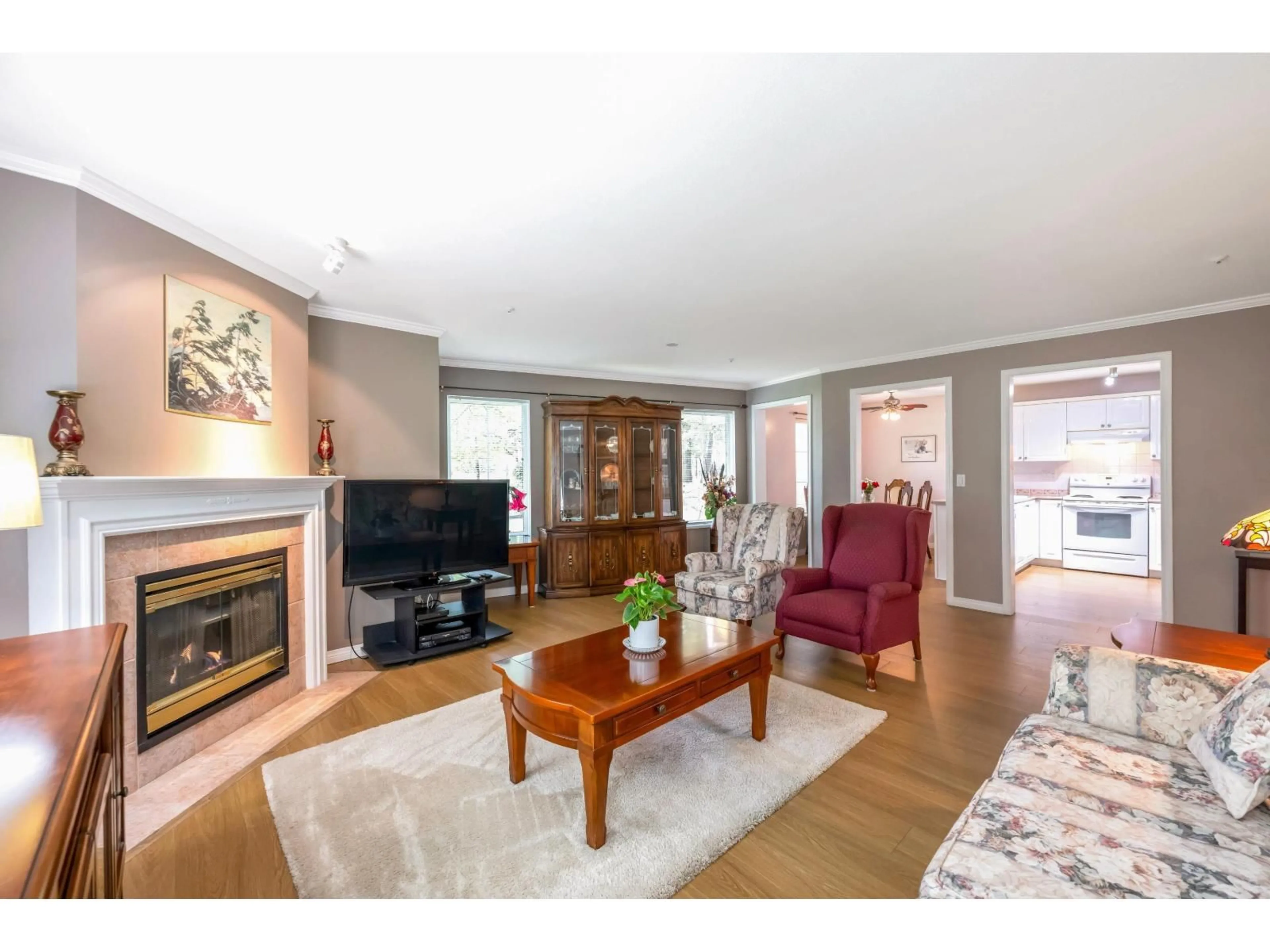 Living room with furniture, wood/laminate floor for 104 - 12155 75A, Surrey British Columbia V3W1B9