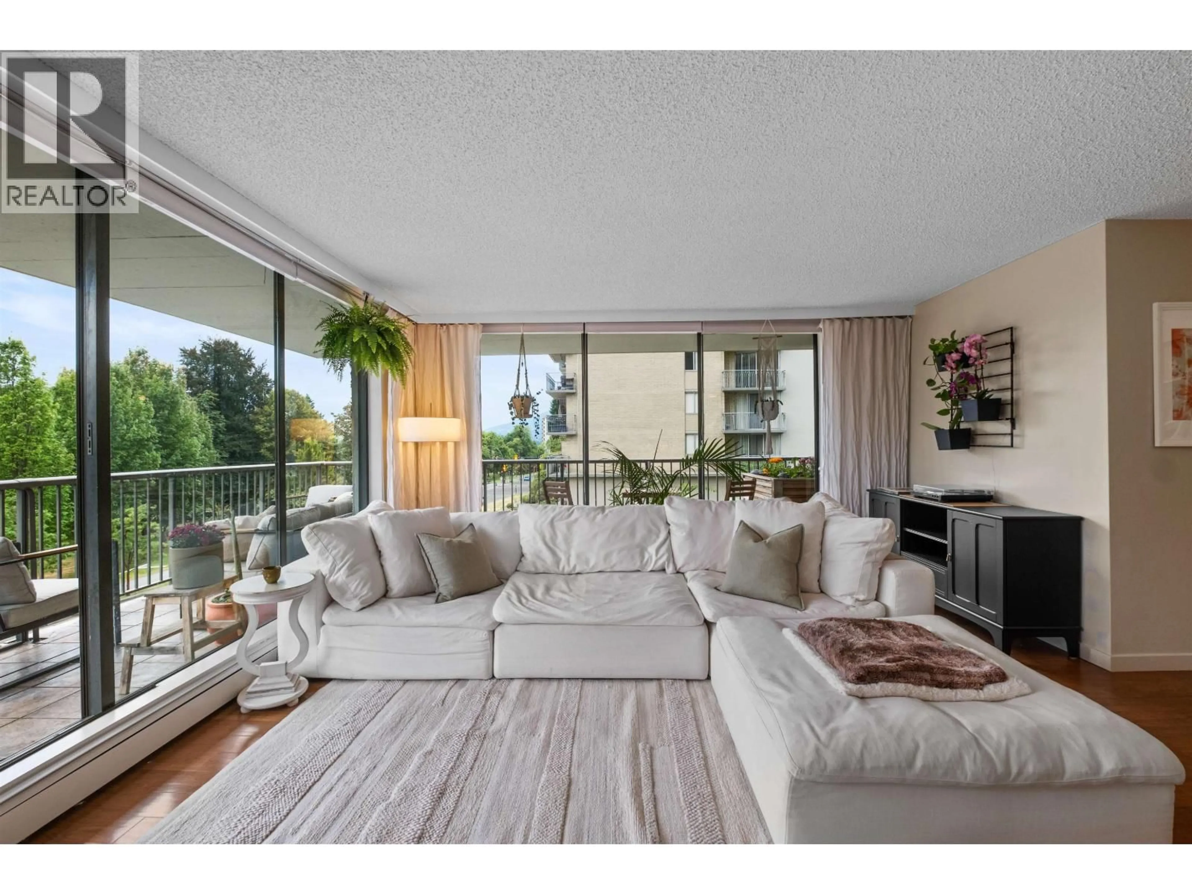 Living room with furniture, wood/laminate floor for 201 - 140 KEITH ROAD, North Vancouver British Columbia V7L4M9