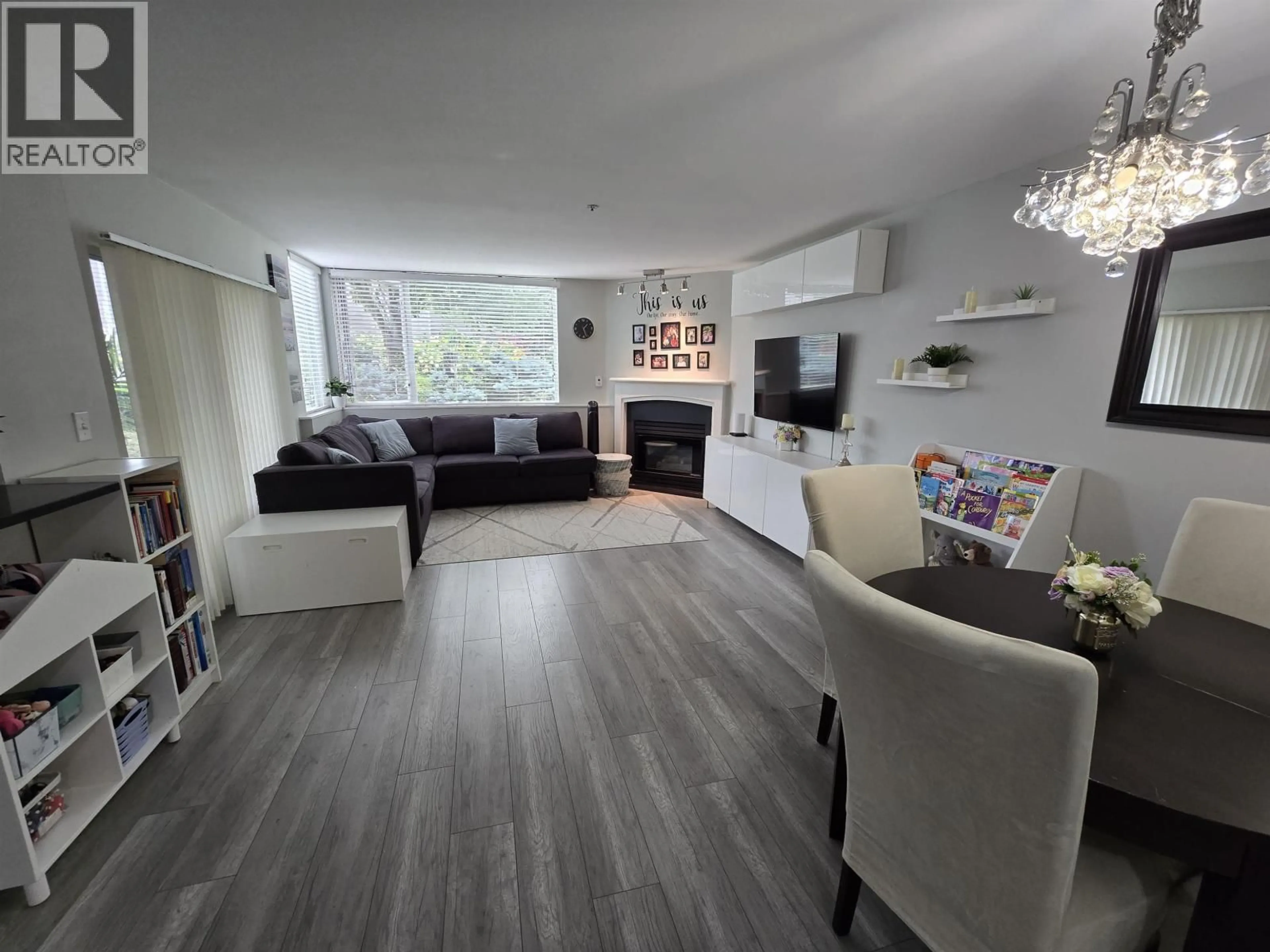 Living room with furniture, wood/laminate floor for 112 - 8460 JELLICOE STREET, Vancouver British Columbia V5S4S8