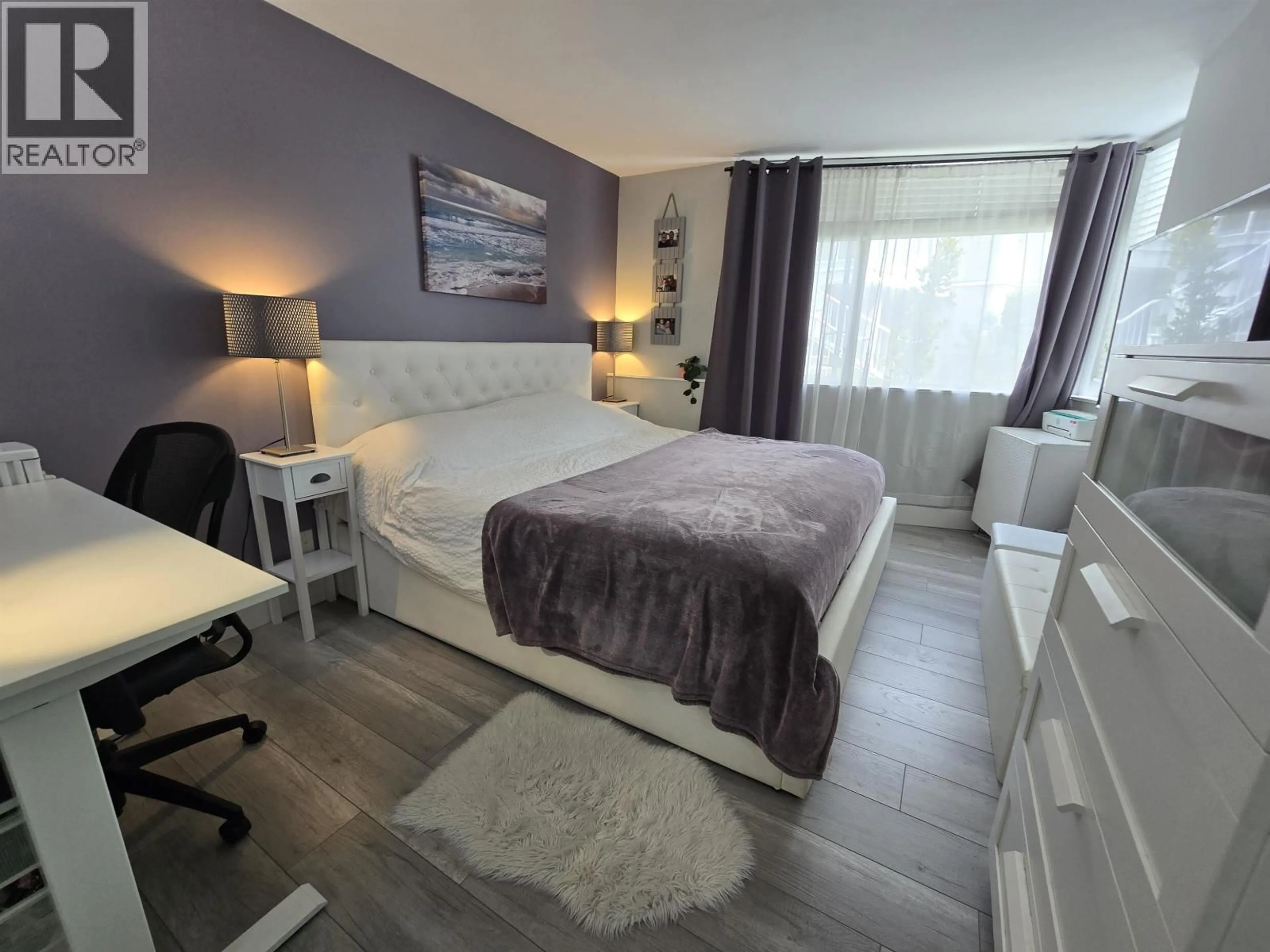 Bedroom with bed, wood/laminate floor for 112 - 8460 JELLICOE STREET, Vancouver British Columbia V5S4S8