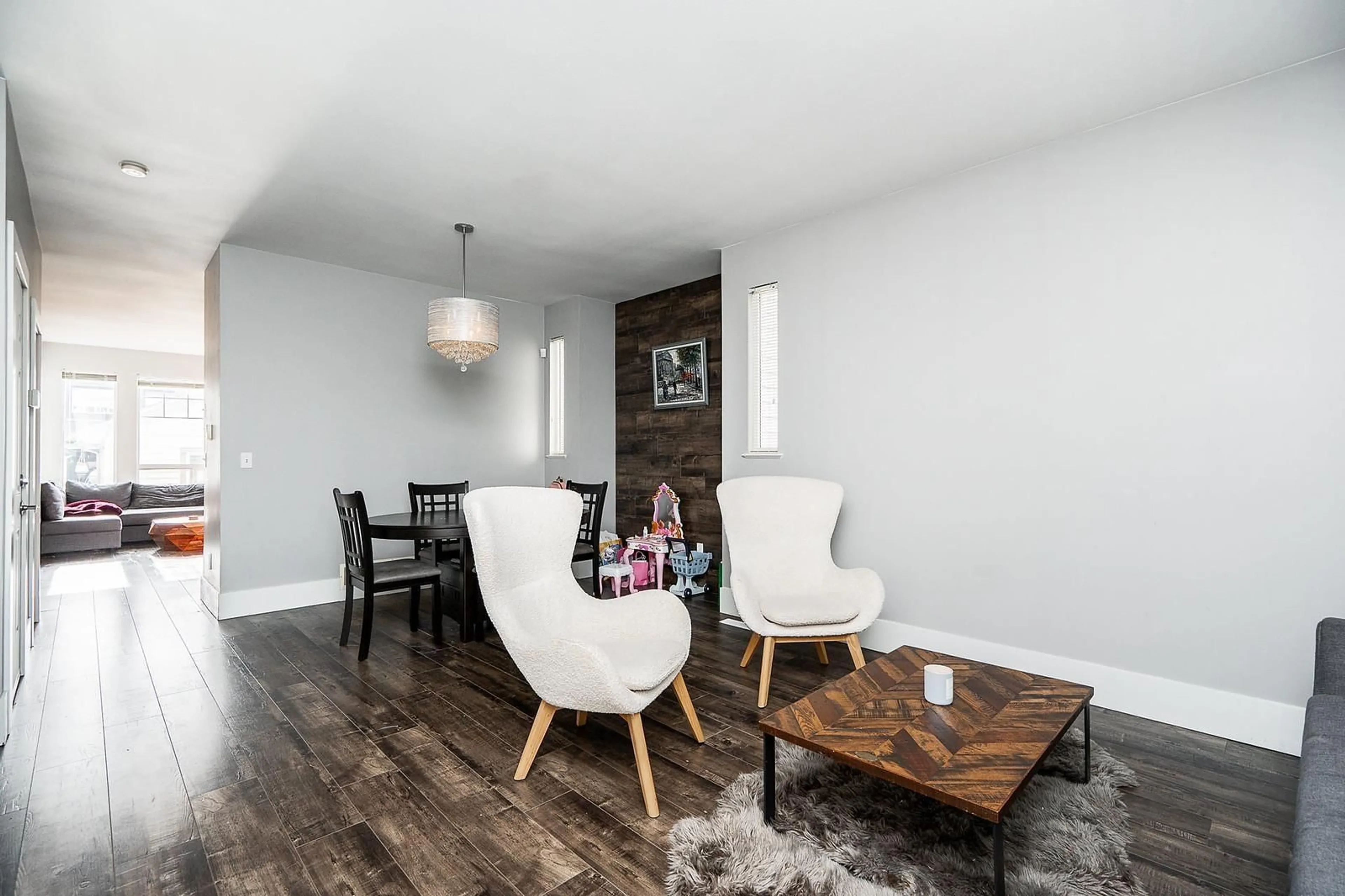 Living room with furniture, wood/laminate floor for 6671 185A, Surrey British Columbia V3S9B7