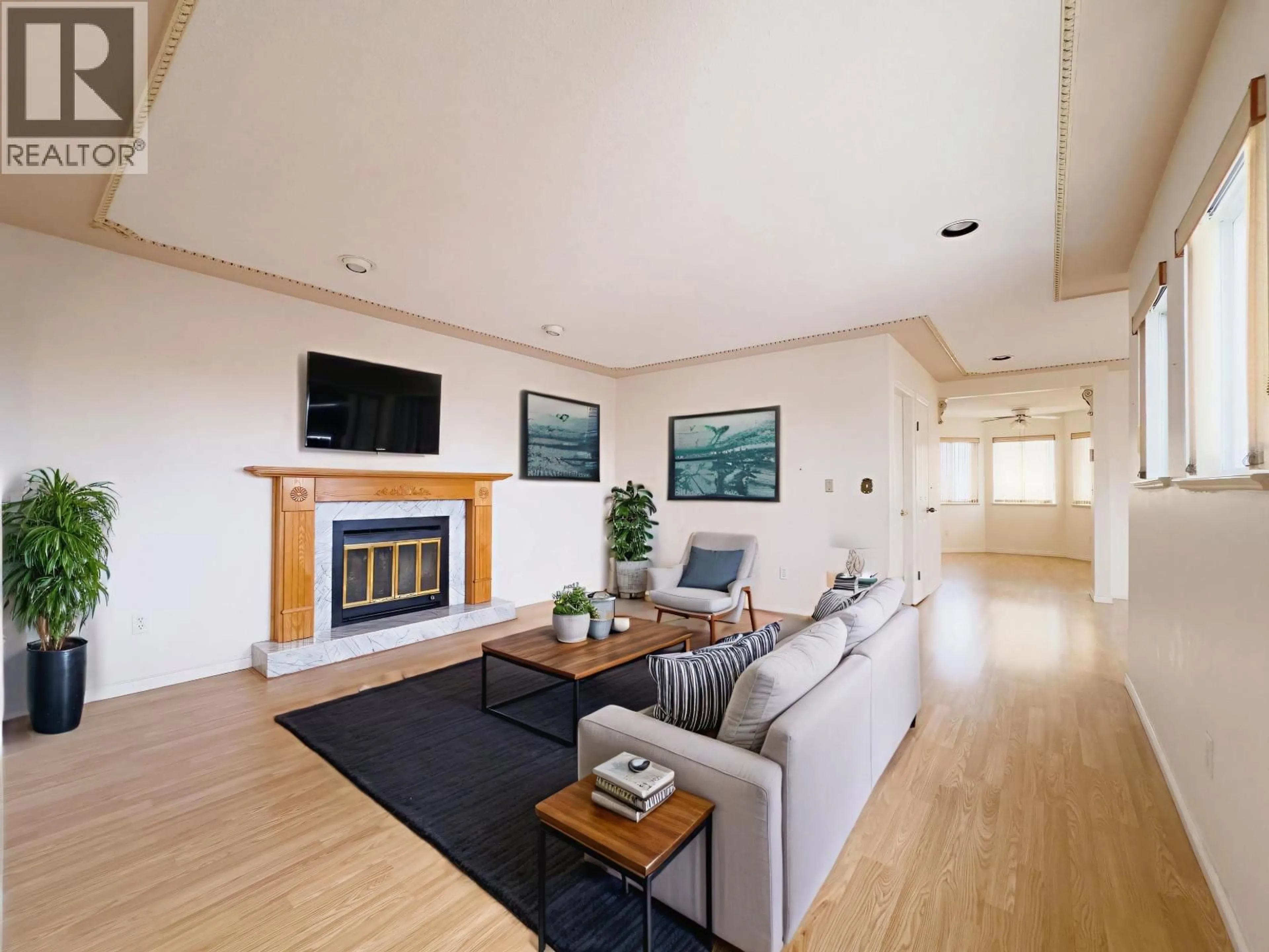 Living room with furniture, wood/laminate floor for 3630 CAMBRIDGE STREET, Vancouver British Columbia V5K1M6