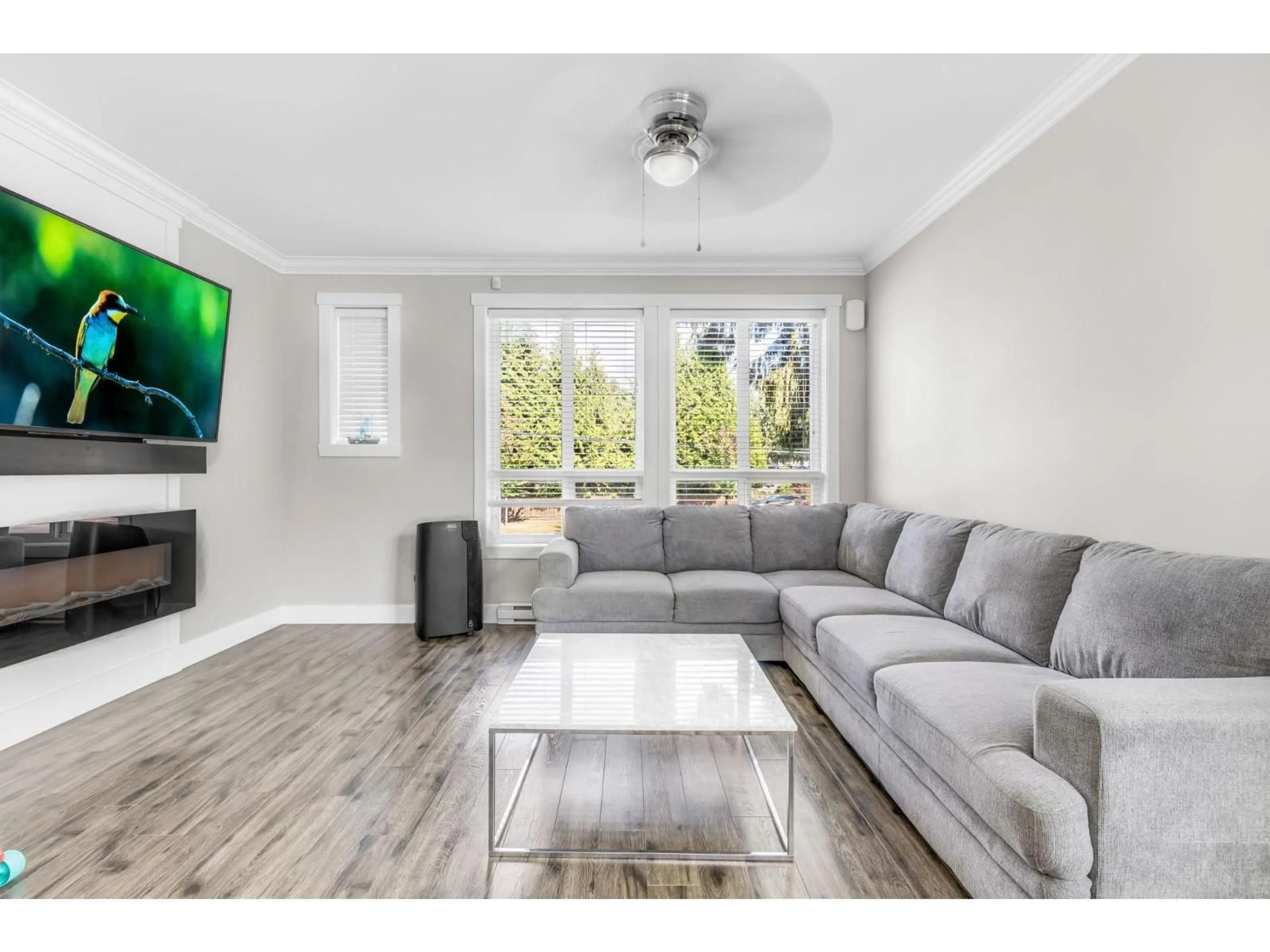 Living room with furniture, wood/laminate floor for 12 - 14388 103, Surrey British Columbia V3T0J1