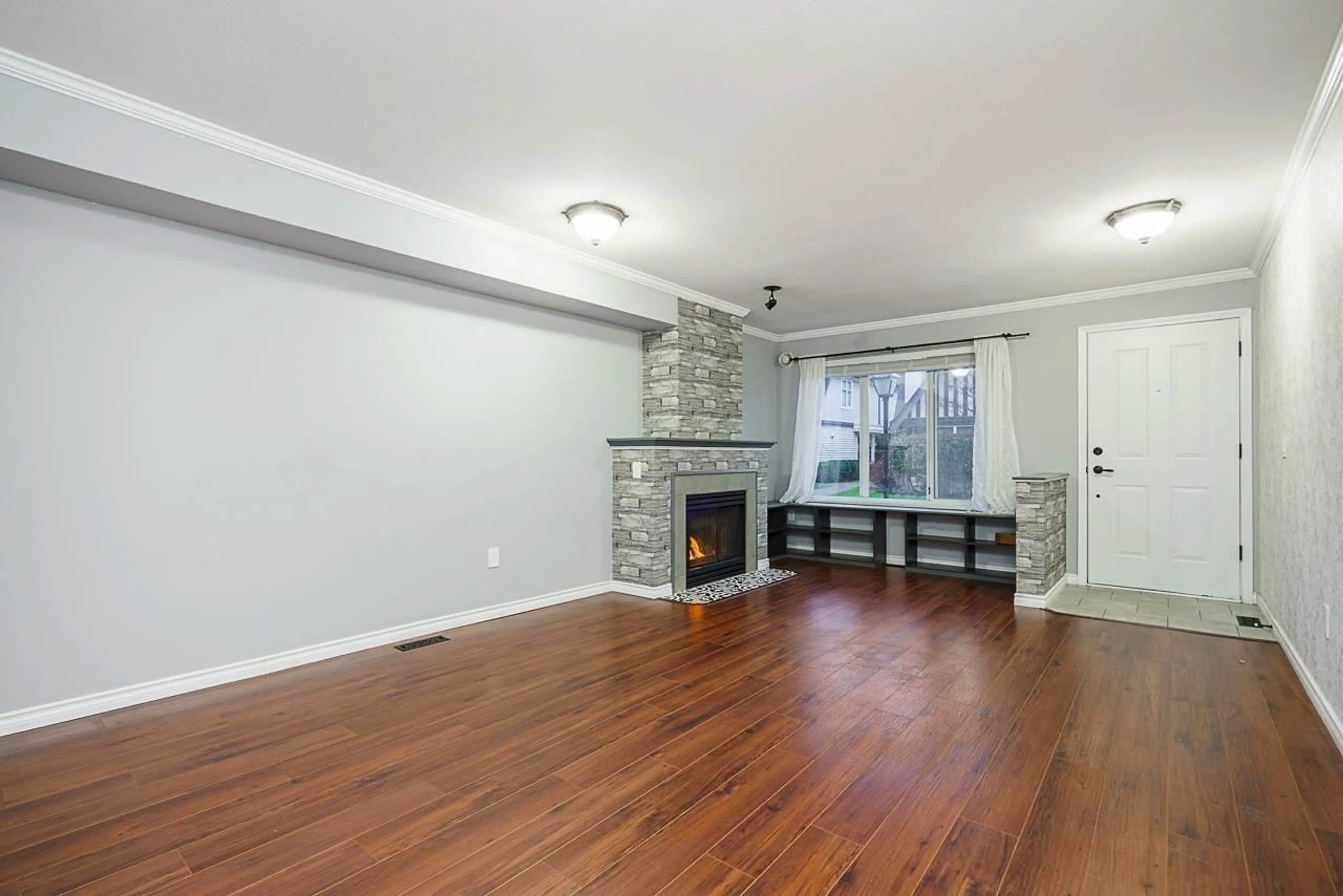 Living room with furniture, wood/laminate floor for 23 - 18883 65, Surrey British Columbia V3S8Y2