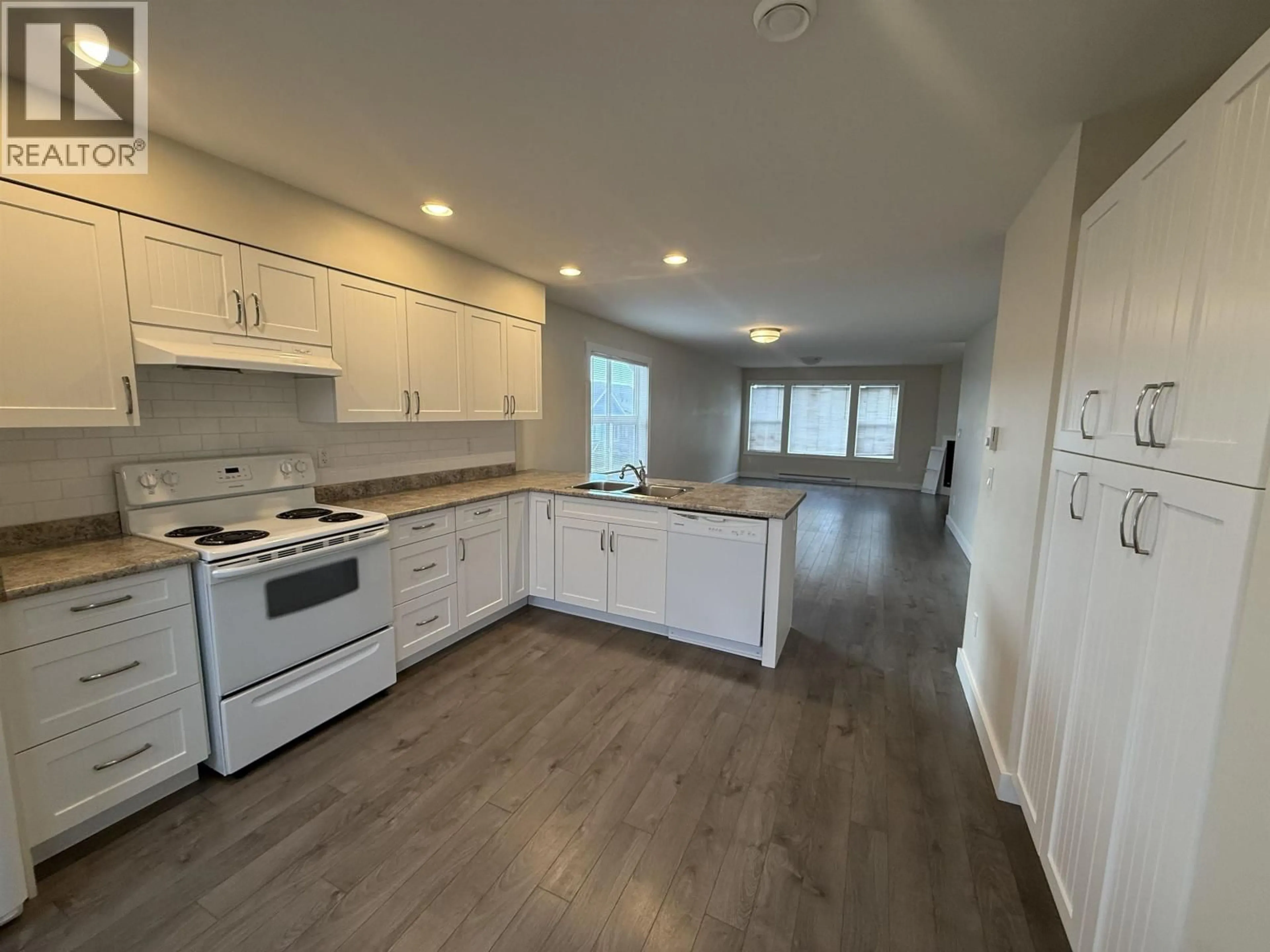Open concept kitchen, wood/laminate floor for 101 - 10303 112 STREET, Fort St. John British Columbia V1J0N6