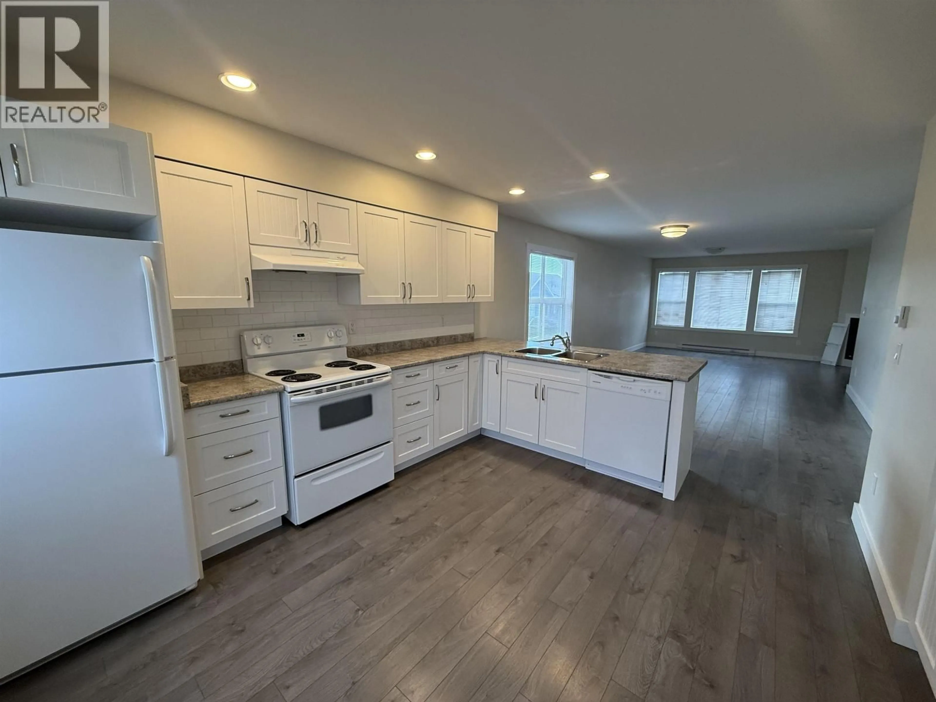Open concept kitchen, wood/laminate floor for 101 - 10303 112 STREET, Fort St. John British Columbia V1J0N6