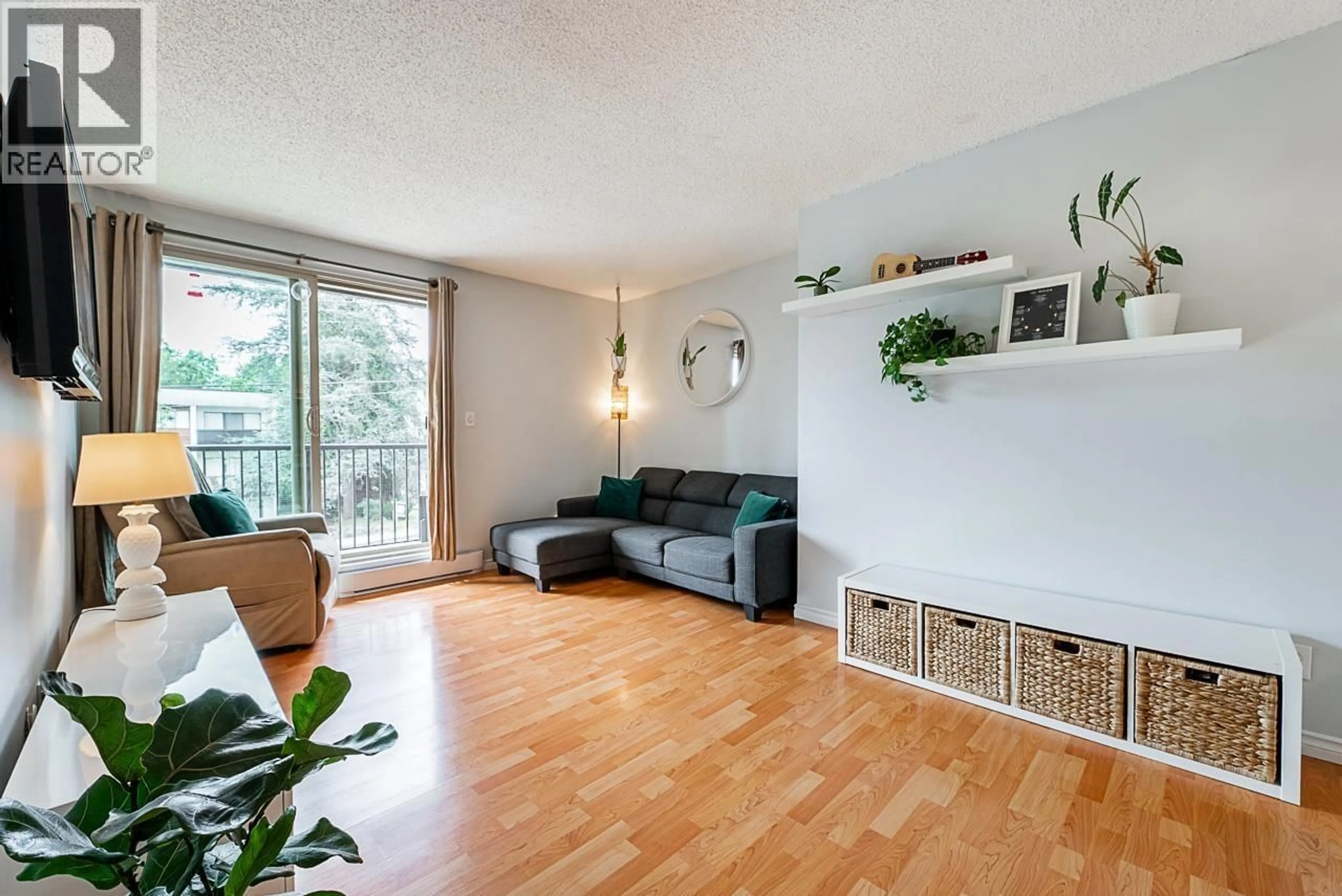 Living room with furniture, wood/laminate floor for 202 - 1103 HOWIE AVENUE, Coquitlam British Columbia V3J1T9