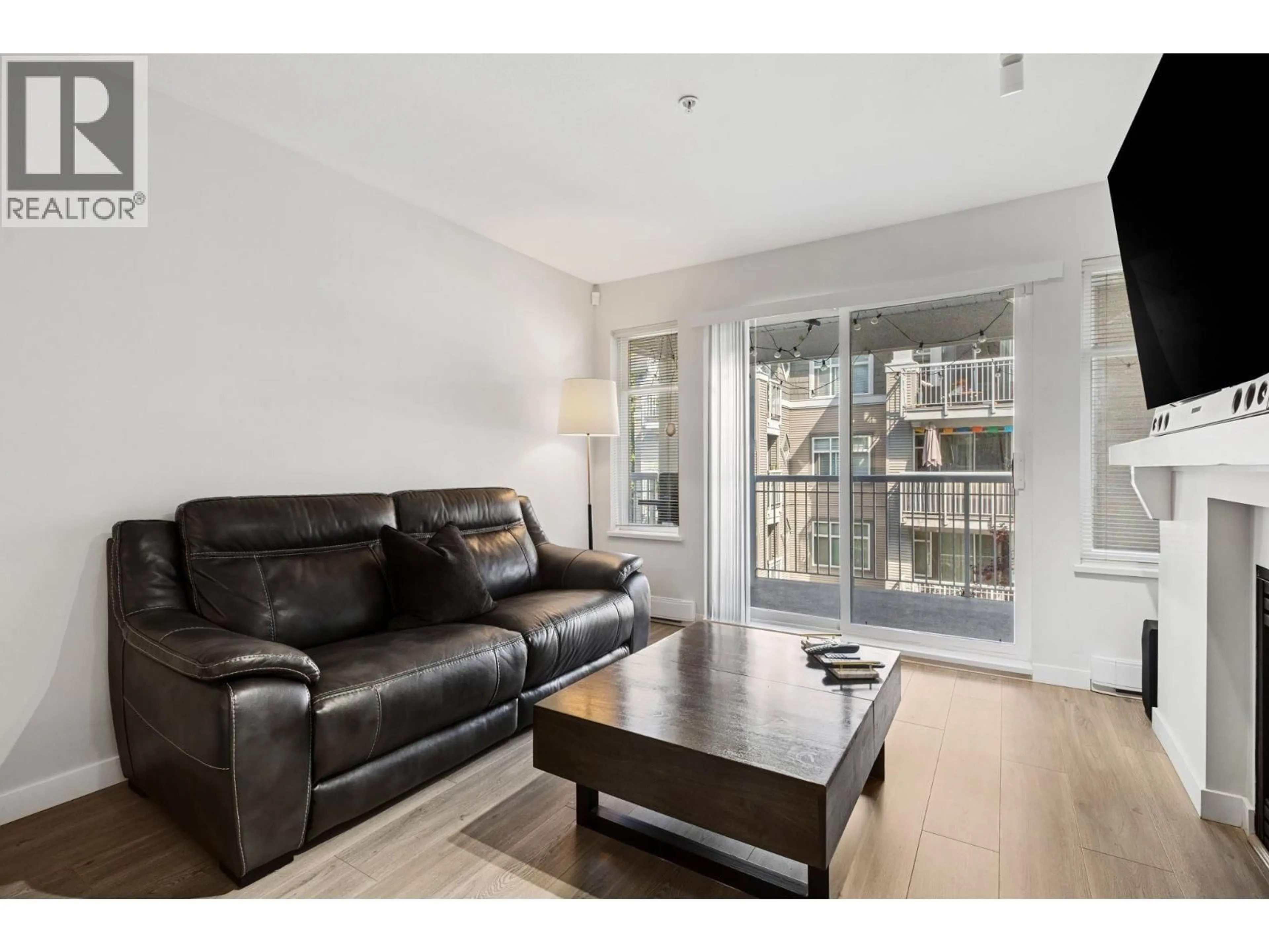 Living room with furniture, wood/laminate floor for 310 - 1438 PARKWAY BOULEVARD, Coquitlam British Columbia V3E3M1