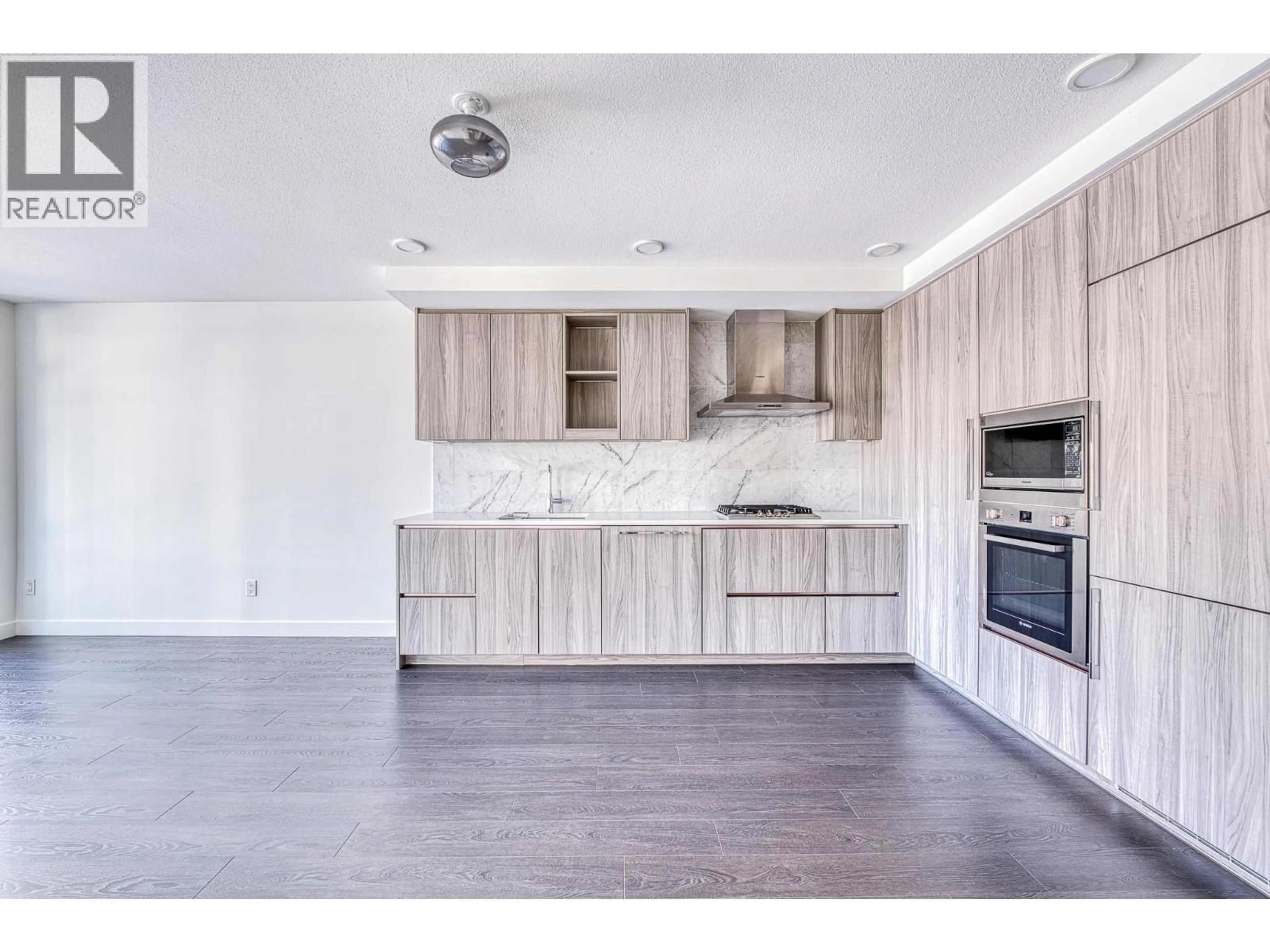 Open concept kitchen, wood/laminate floor for 509 - 8800 HAZELBRIDGE WAY, Richmond British Columbia V6X0S3
