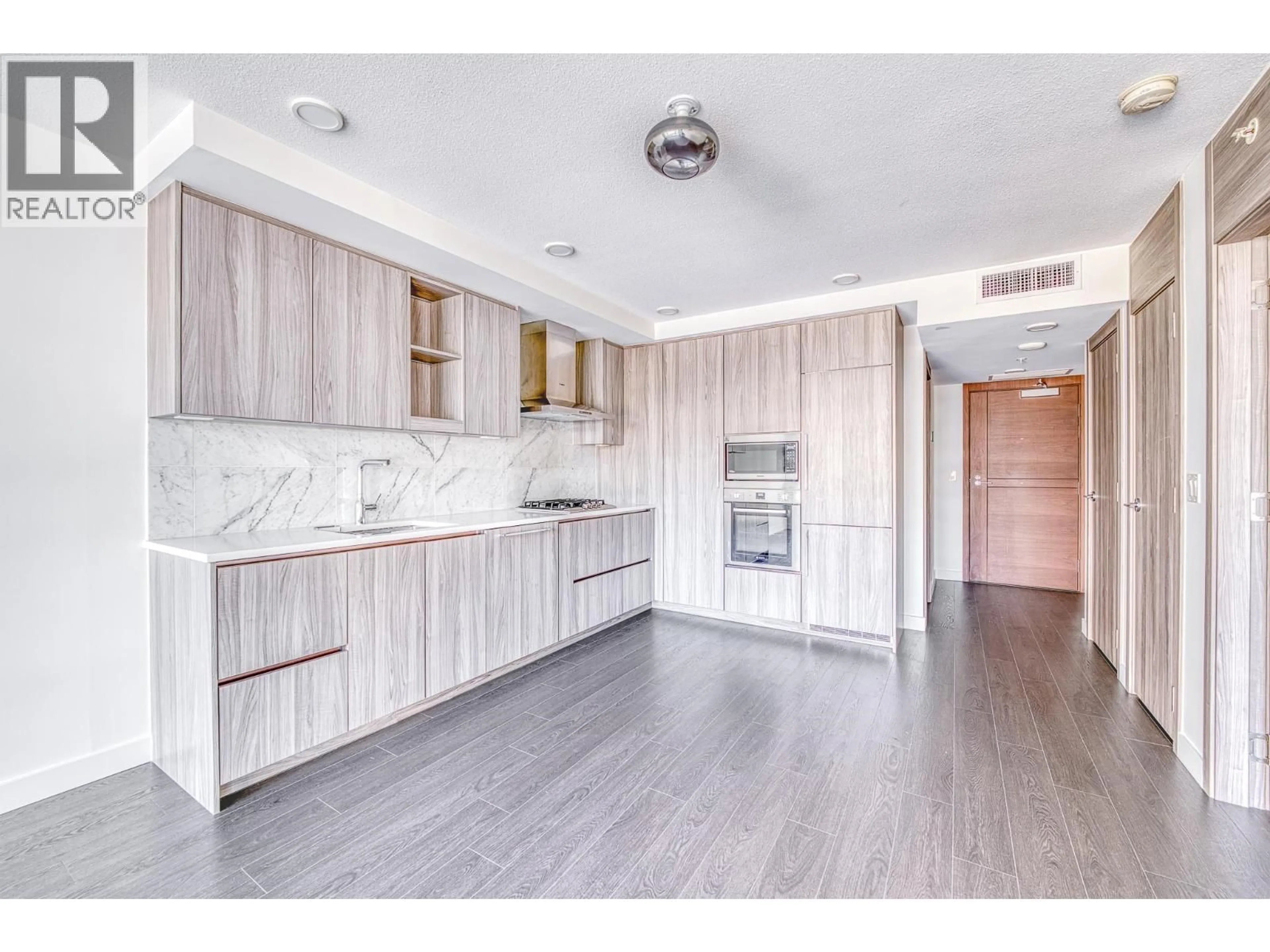 Open concept kitchen, wood/laminate floor for 509 - 8800 HAZELBRIDGE WAY, Richmond British Columbia V6X0S3