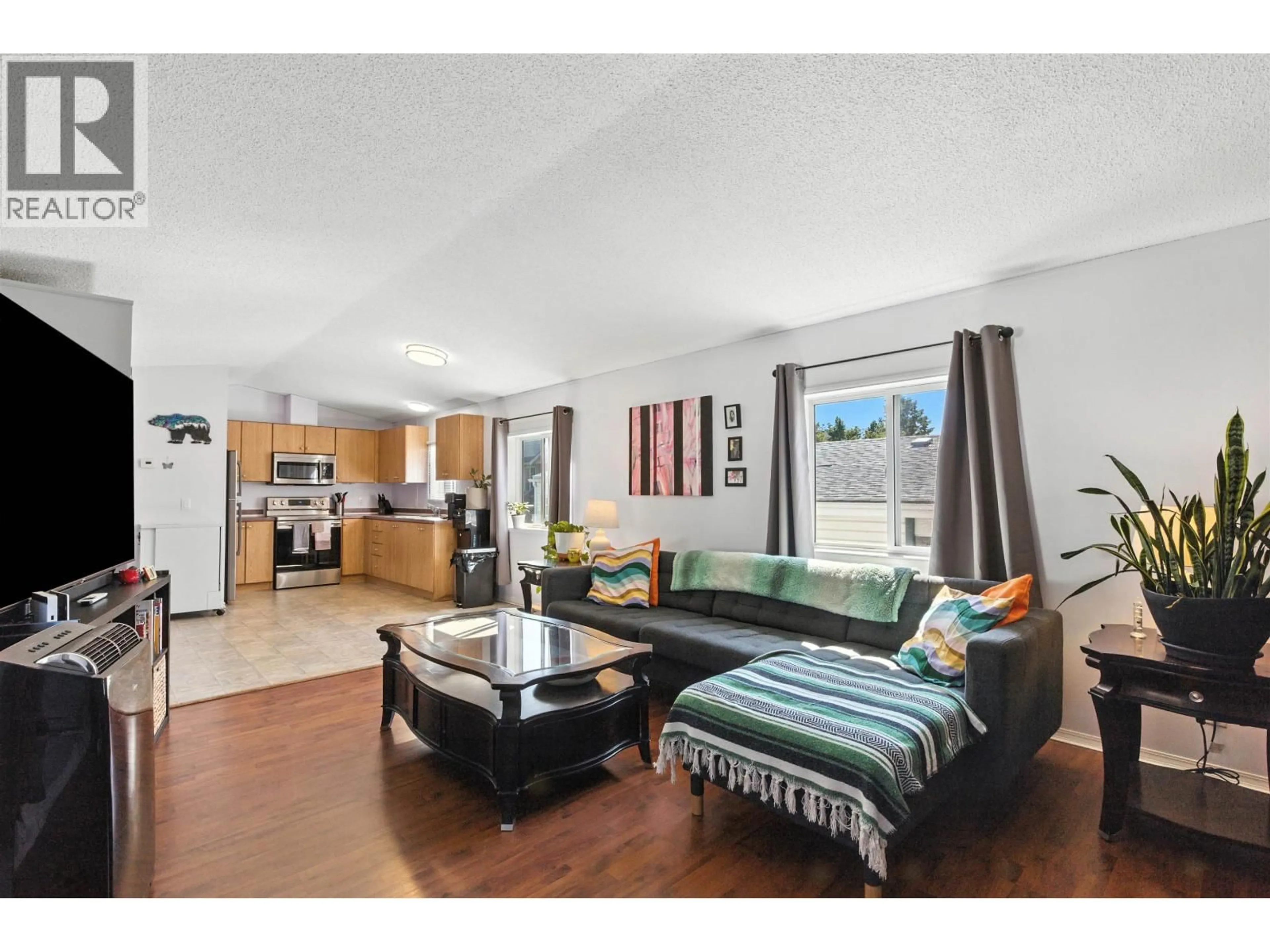 Living room with furniture, wood/laminate floor for 232 LONGHORN DRIVE, Williams Lake British Columbia V2G4T7