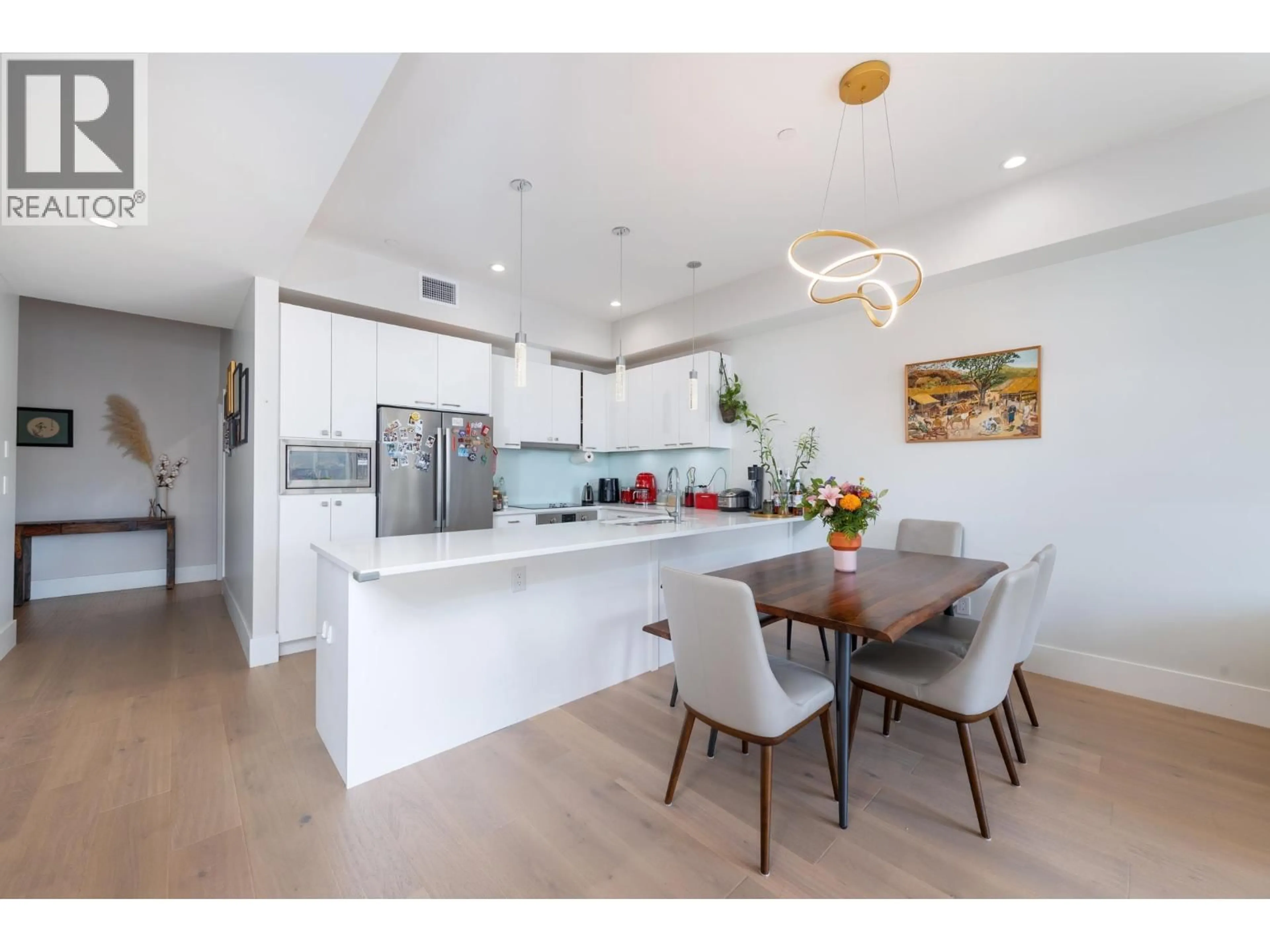 Open concept kitchen, wood/laminate floor for 205 - 1591 BOWSER AVENUE, North Vancouver British Columbia V7P2Y4
