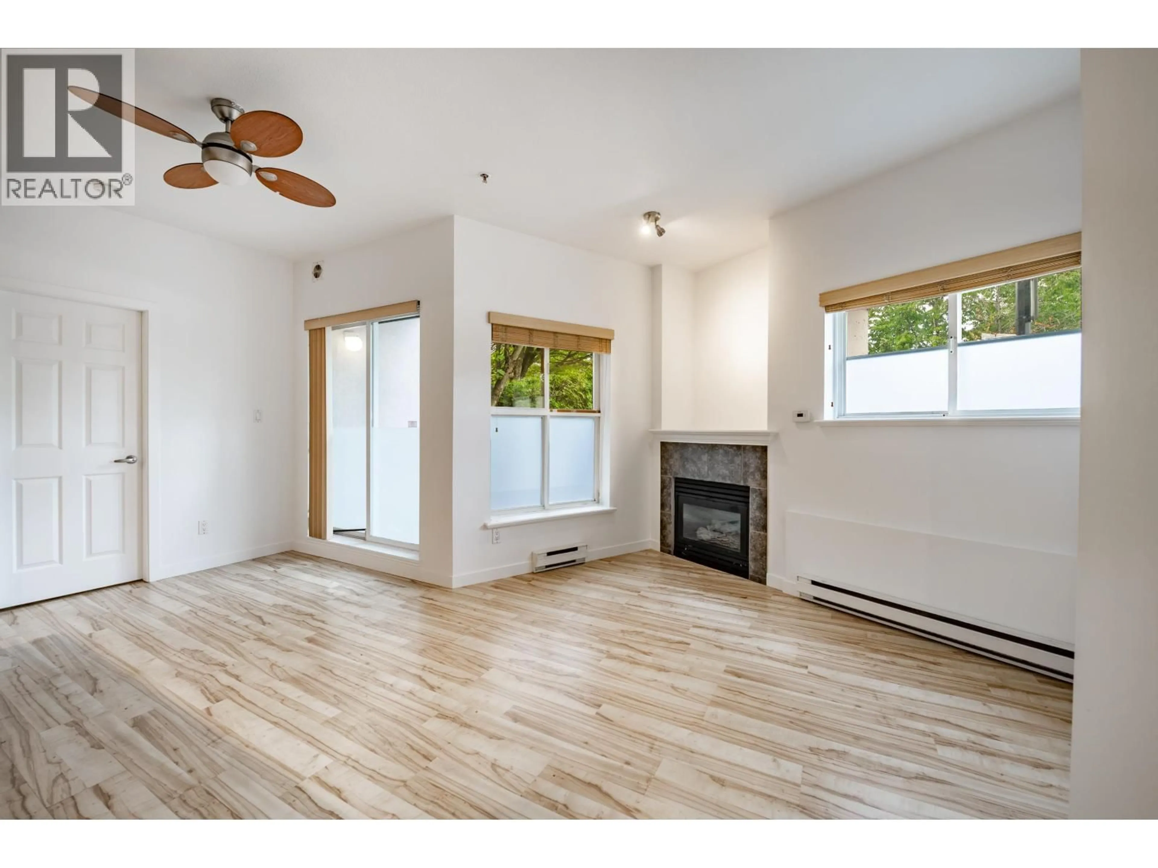Living room with furniture, wood/laminate floor for 103 - 1688 8TH AVENUE, Vancouver British Columbia V5N1T5