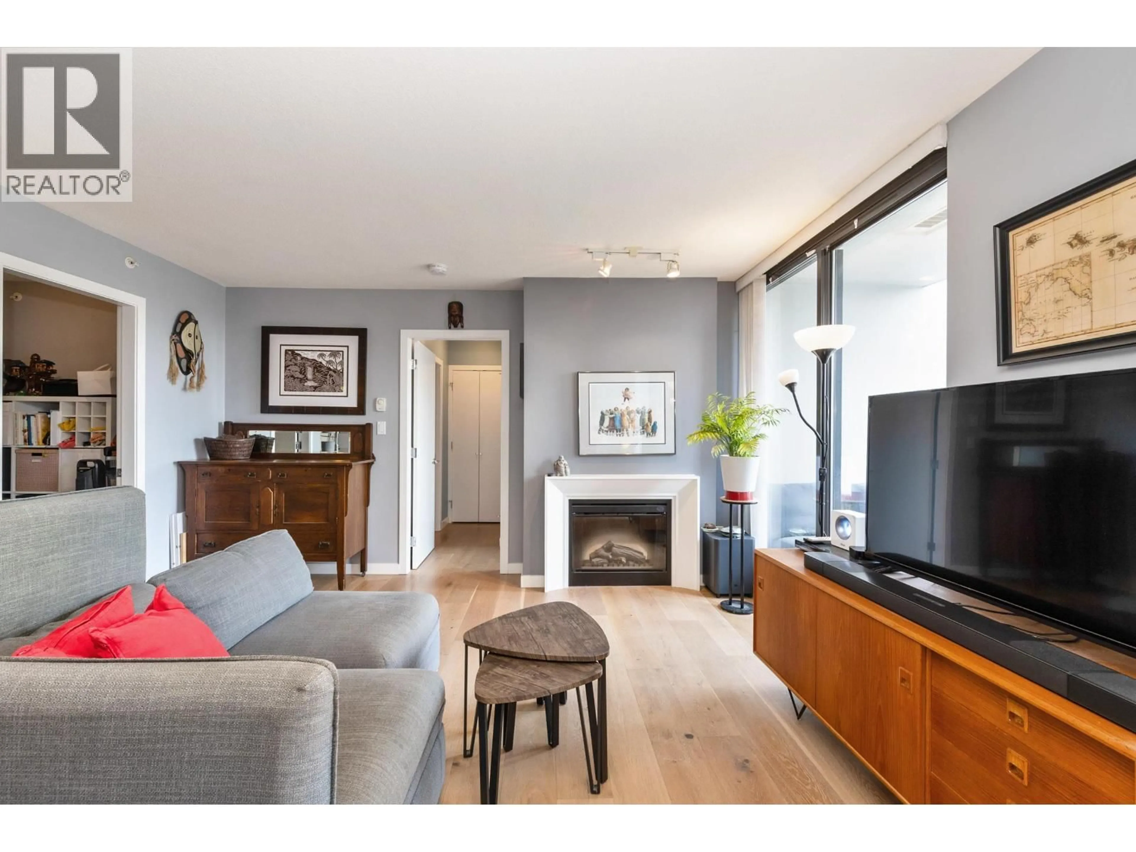 Living room with furniture, wood/laminate floor for 701 - 1185 THE HIGH STREET, Coquitlam British Columbia V3B0A9