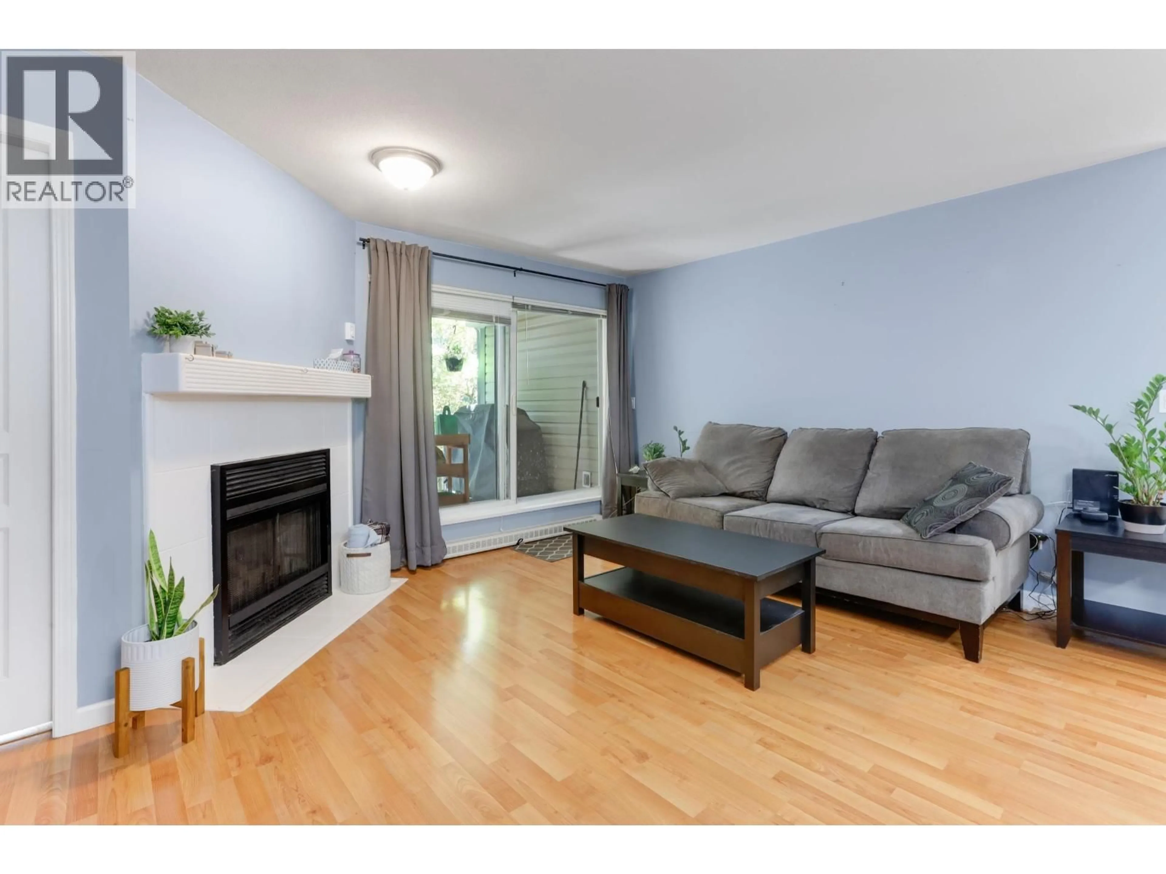 Living room with furniture, wood/laminate floor for 204 - 2439 WILSON AVENUE, Port Coquitlam British Columbia V3C6H6