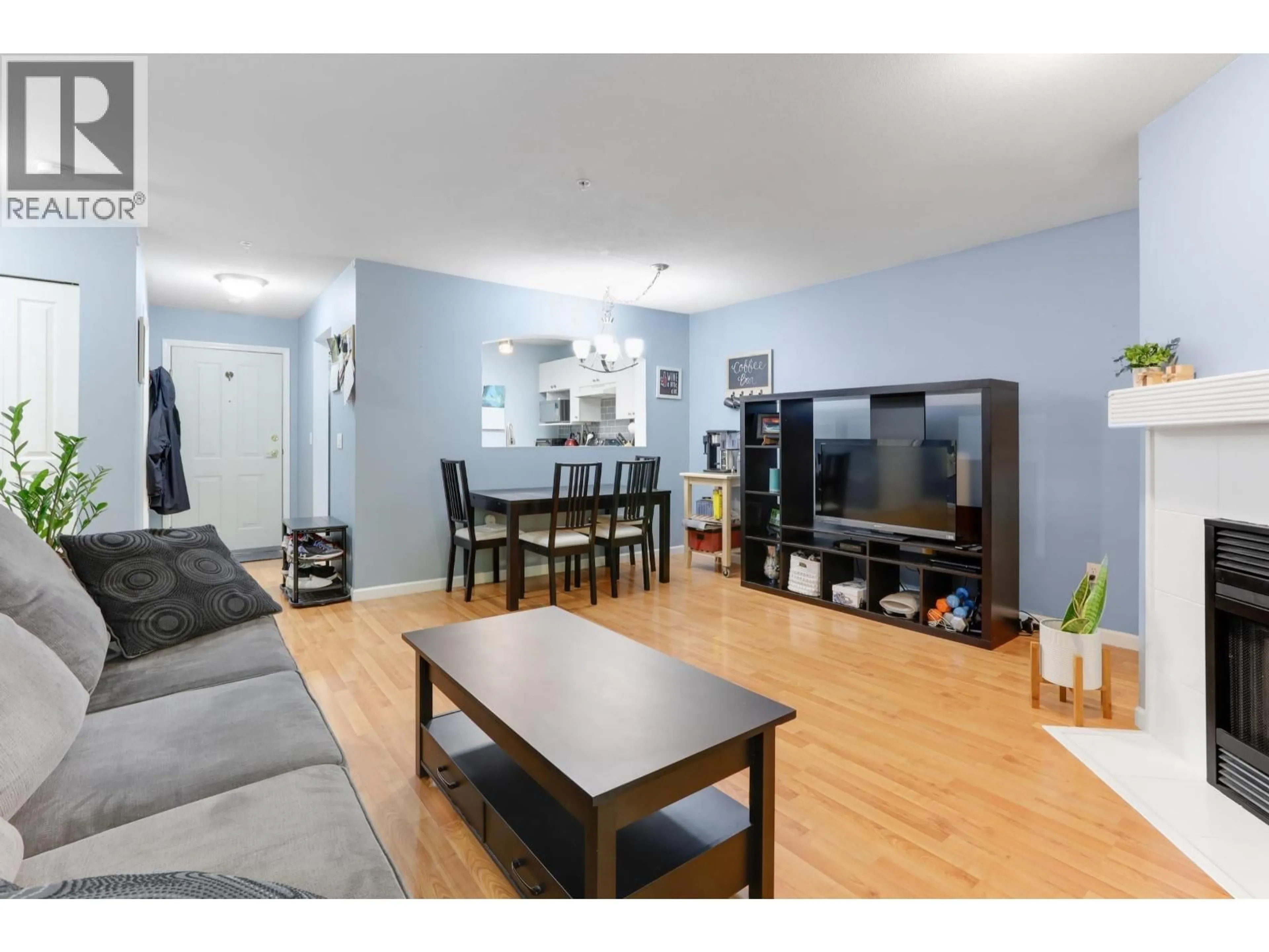 Living room with furniture, wood/laminate floor for 204 - 2439 WILSON AVENUE, Port Coquitlam British Columbia V3C6H6