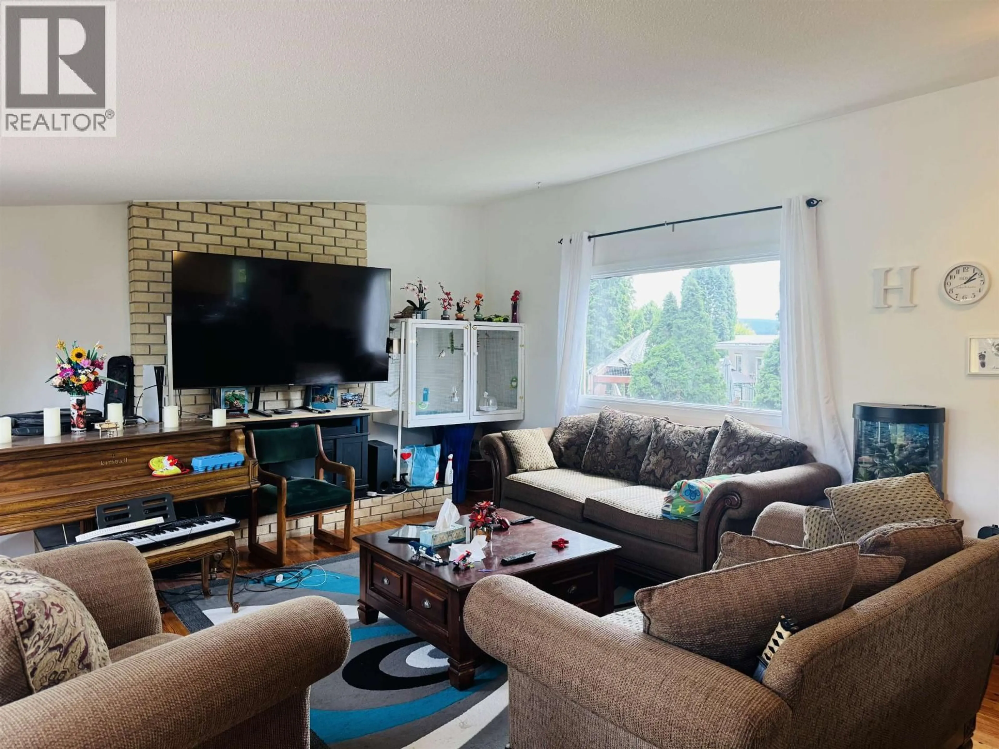 Living room with furniture, wood/laminate floor for 1140 PIGEON AVENUE, Williams Lake British Columbia V2G2C1