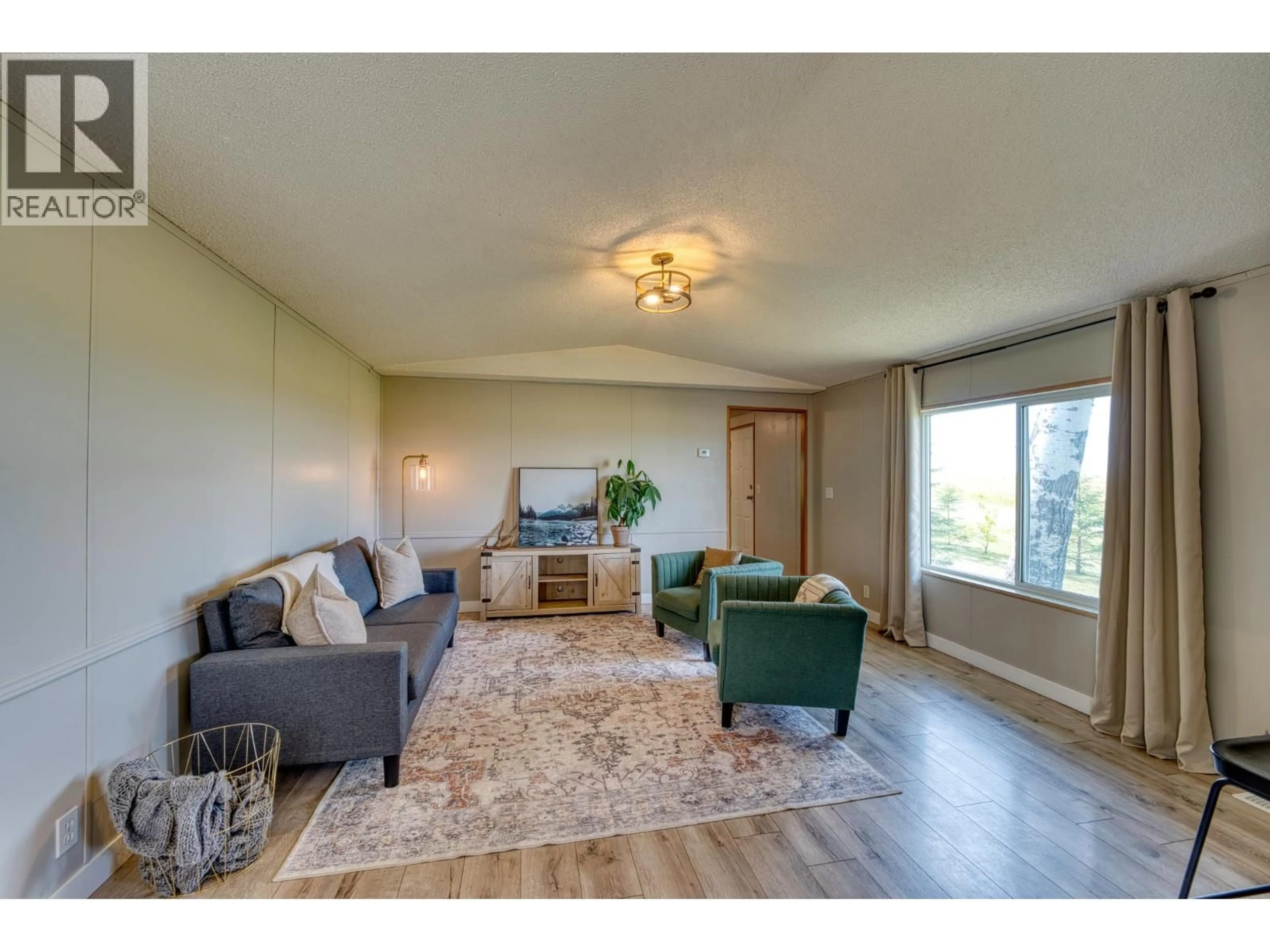 Living room with furniture, wood/laminate floor for 11075 257 ROAD, Fort St. John British Columbia V1J8C2