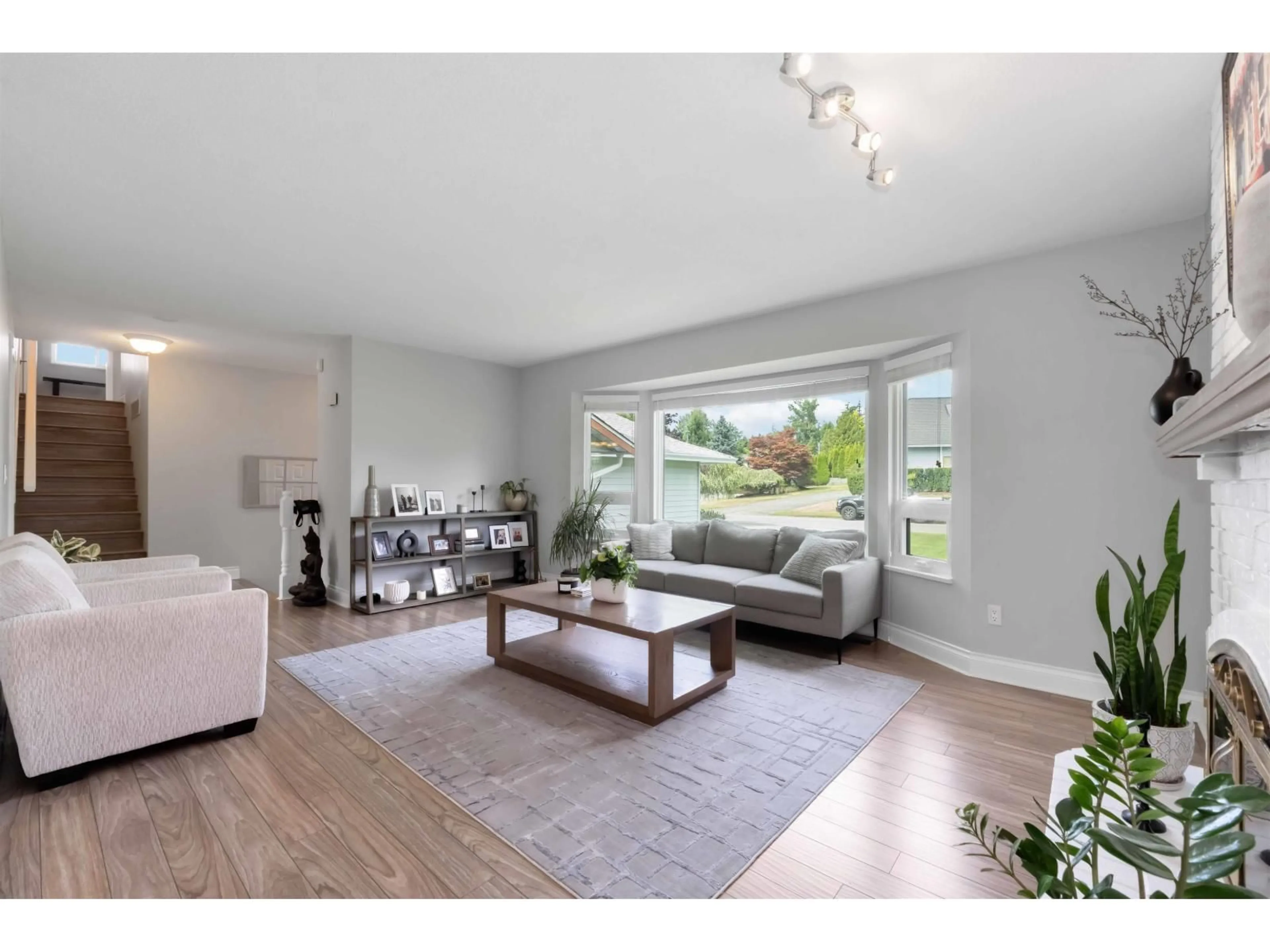 Living room with furniture, wood/laminate floor for 18166 54, Surrey British Columbia V3S7Z1