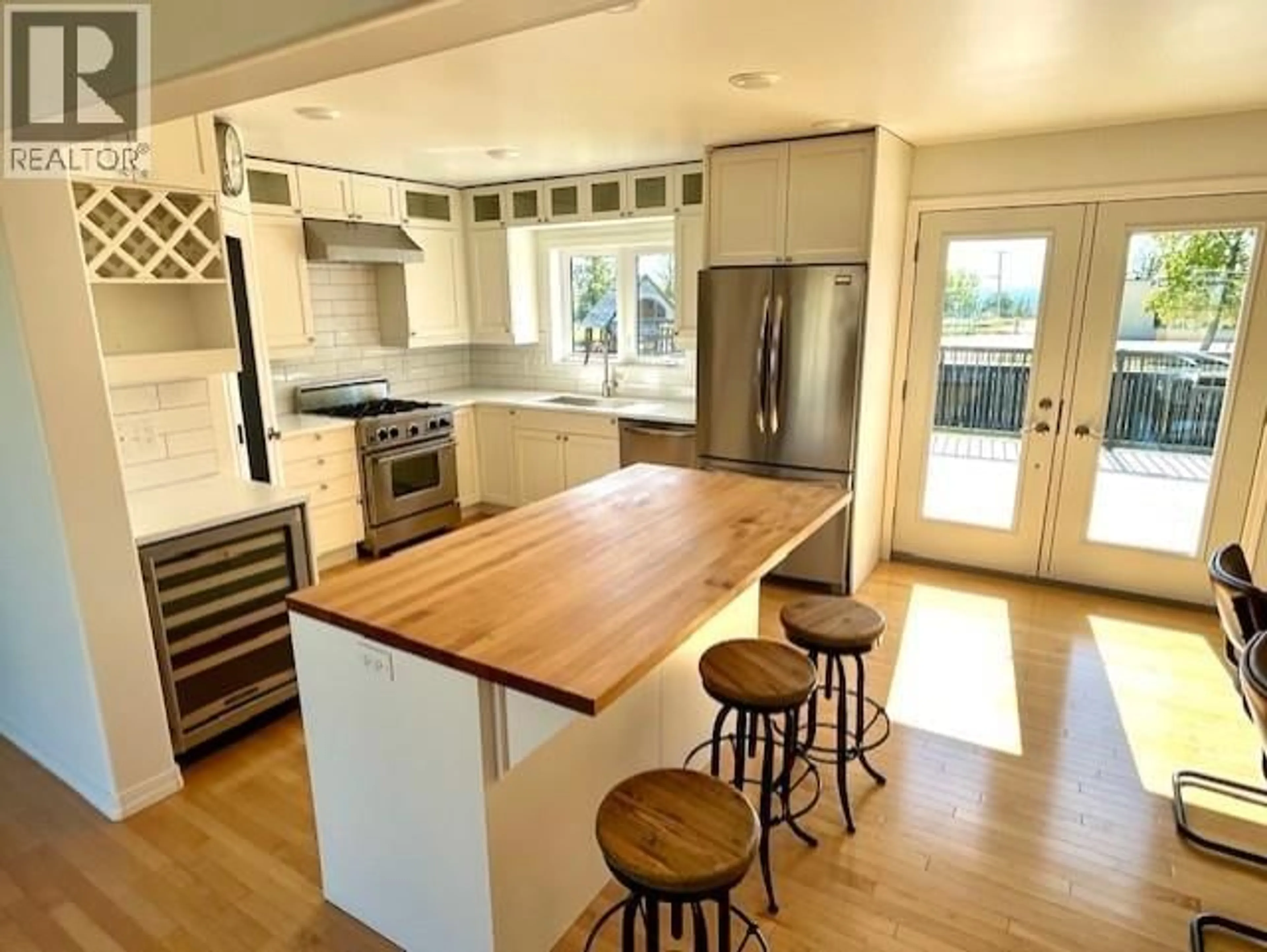 Open concept kitchen, wood/laminate floor for 5611 ANGUS COURT, Fort Nelson British Columbia V0C1R0