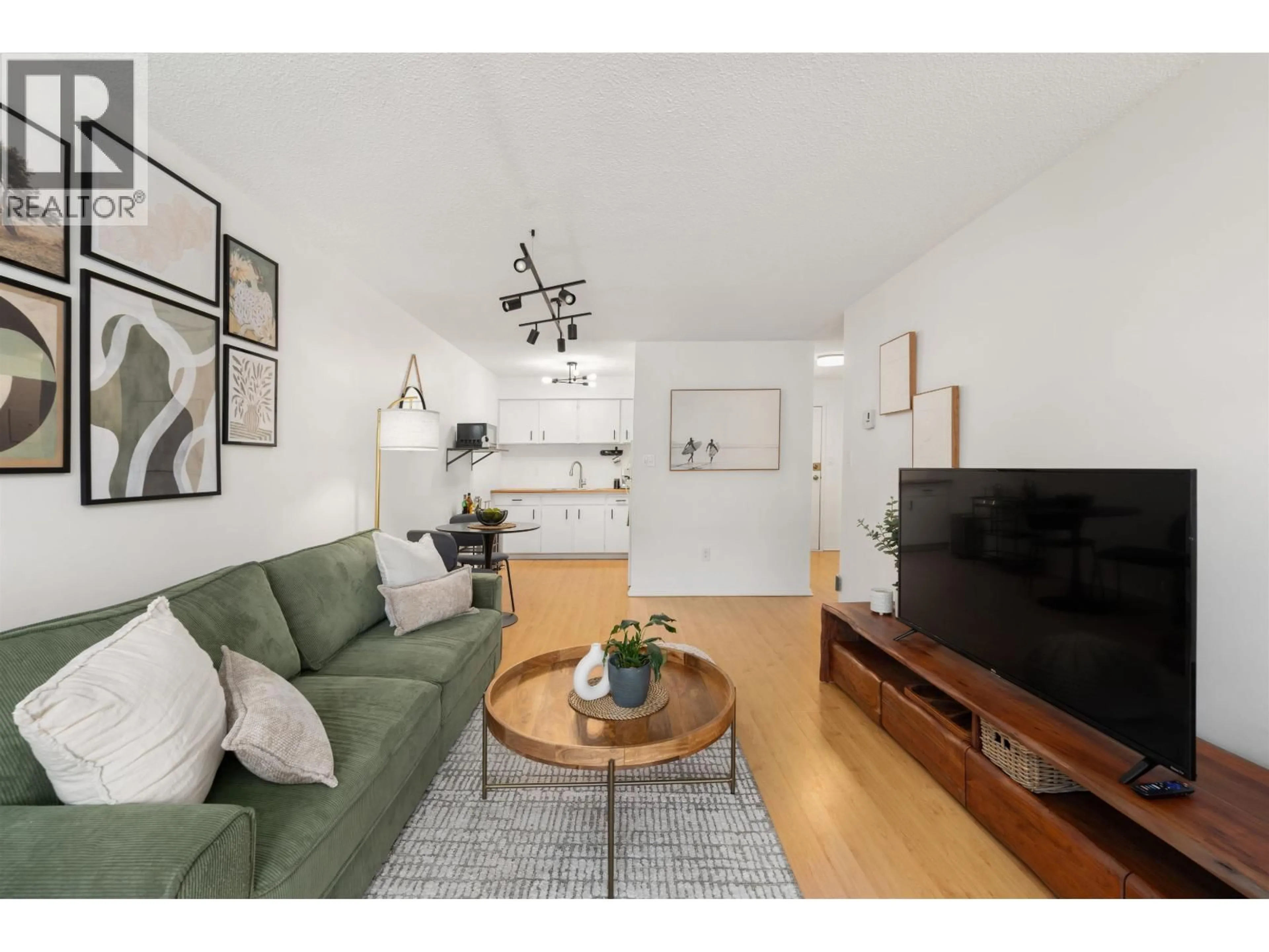 Living room with furniture, wood/laminate floor for 304 - 212 FORBES AVENUE, North Vancouver British Columbia V7M3E5