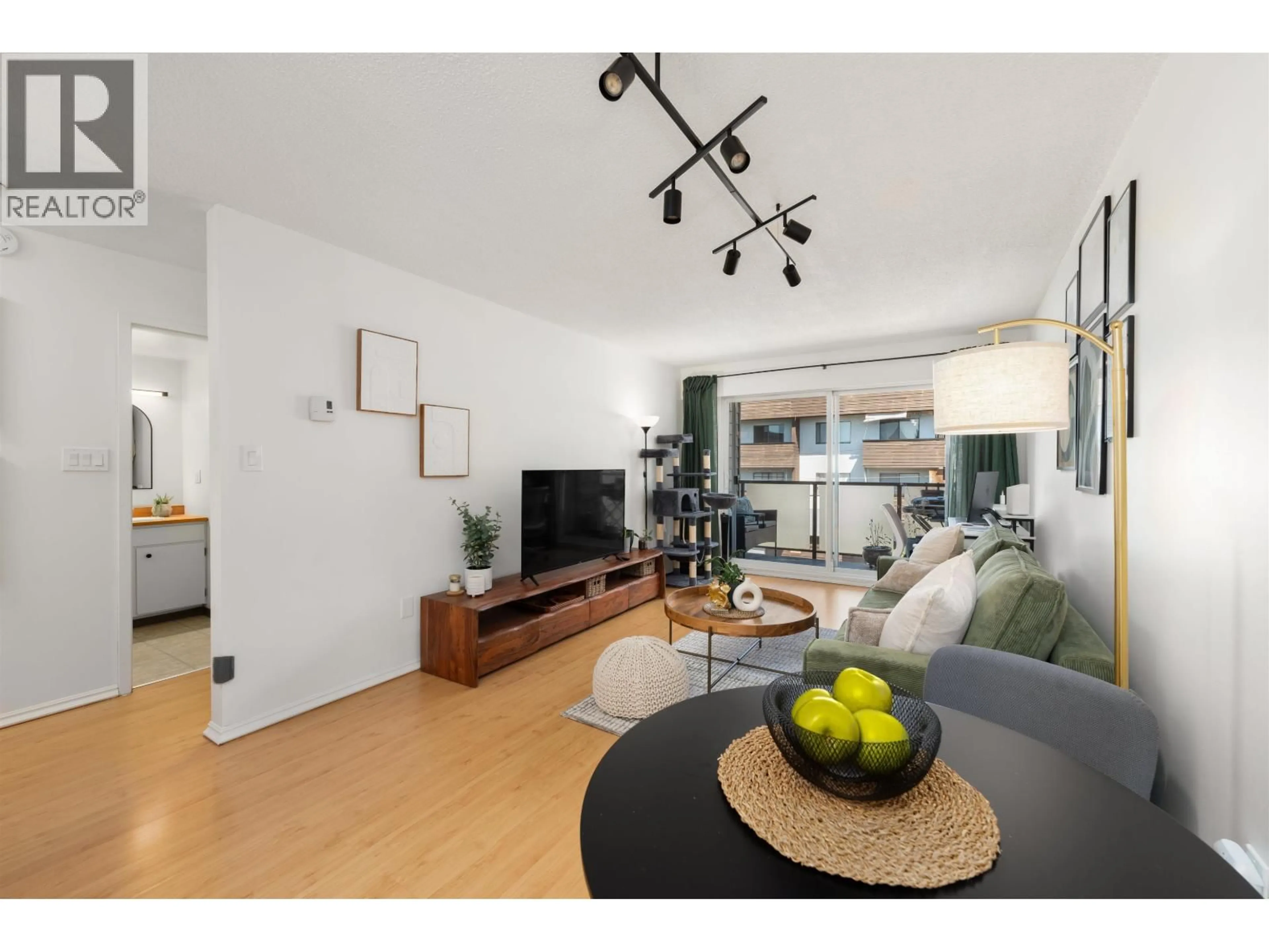 Living room with furniture, wood/laminate floor for 304 - 212 FORBES AVENUE, North Vancouver British Columbia V7M3E5