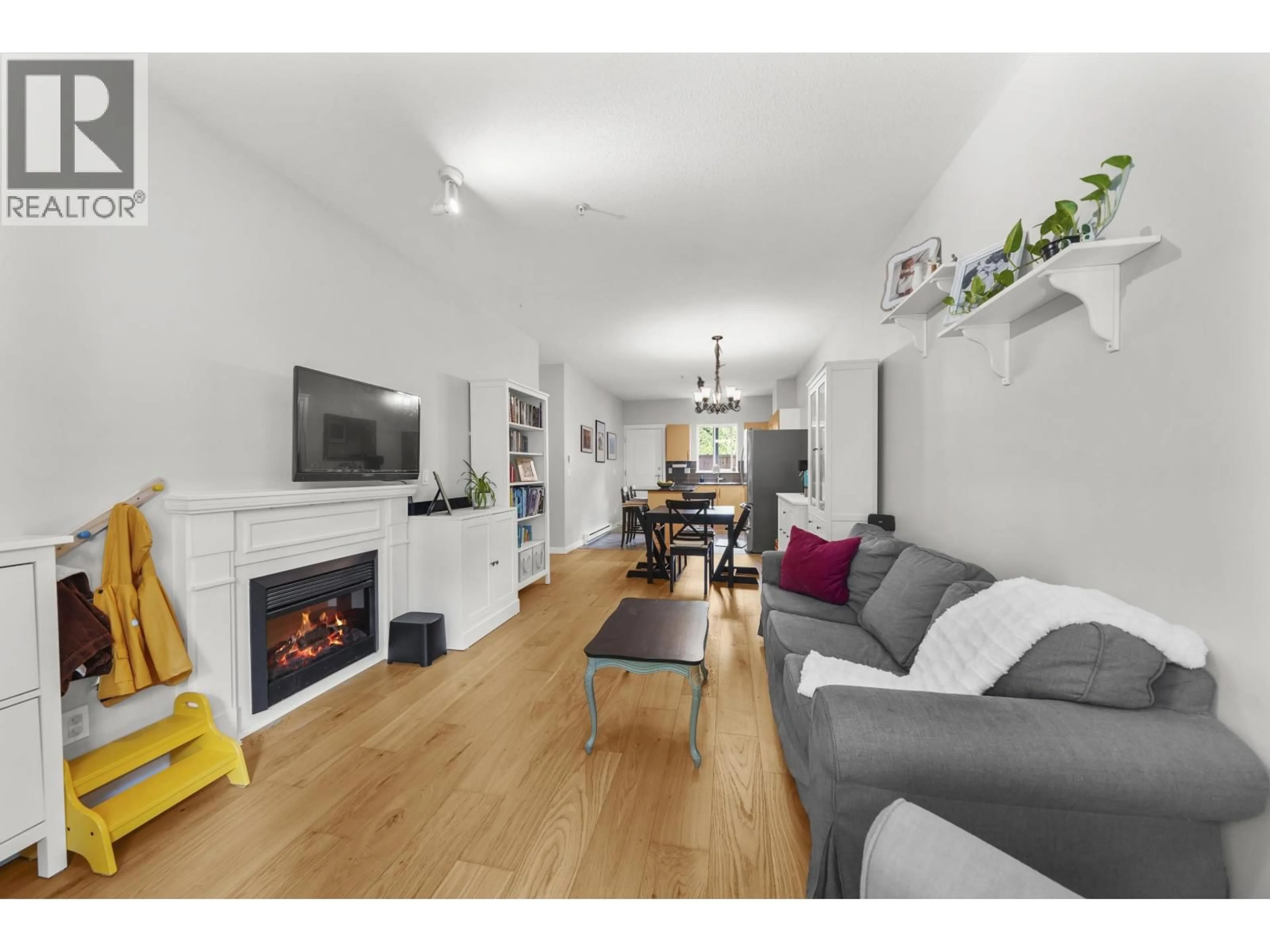 Living room with furniture, wood/laminate floor for 616 - 1661 FRASER AVENUE, Port Coquitlam British Columbia V3B0B6