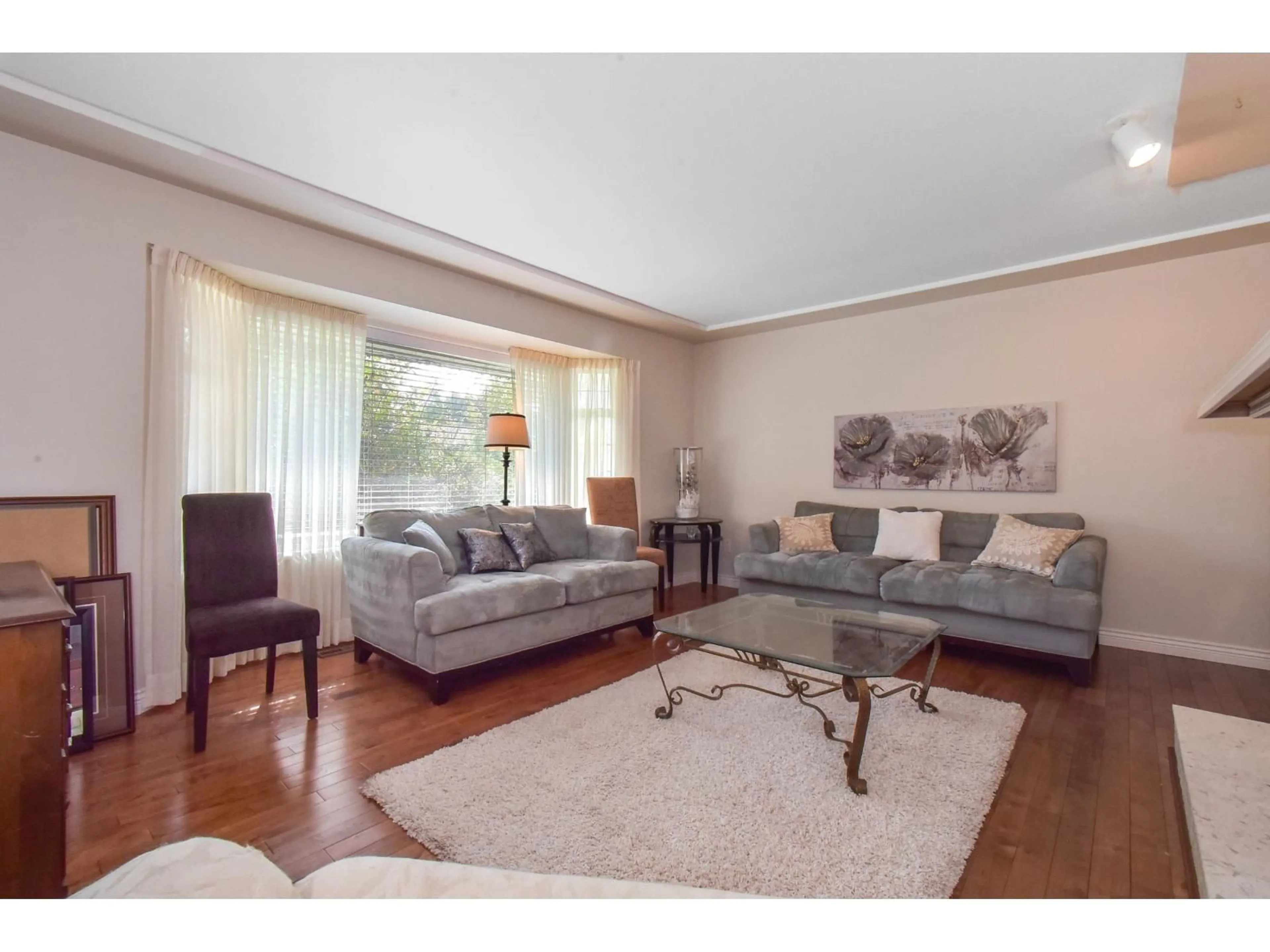 Living room with furniture, wood/laminate floor for 5533 183A, Surrey British Columbia V3S7Z3