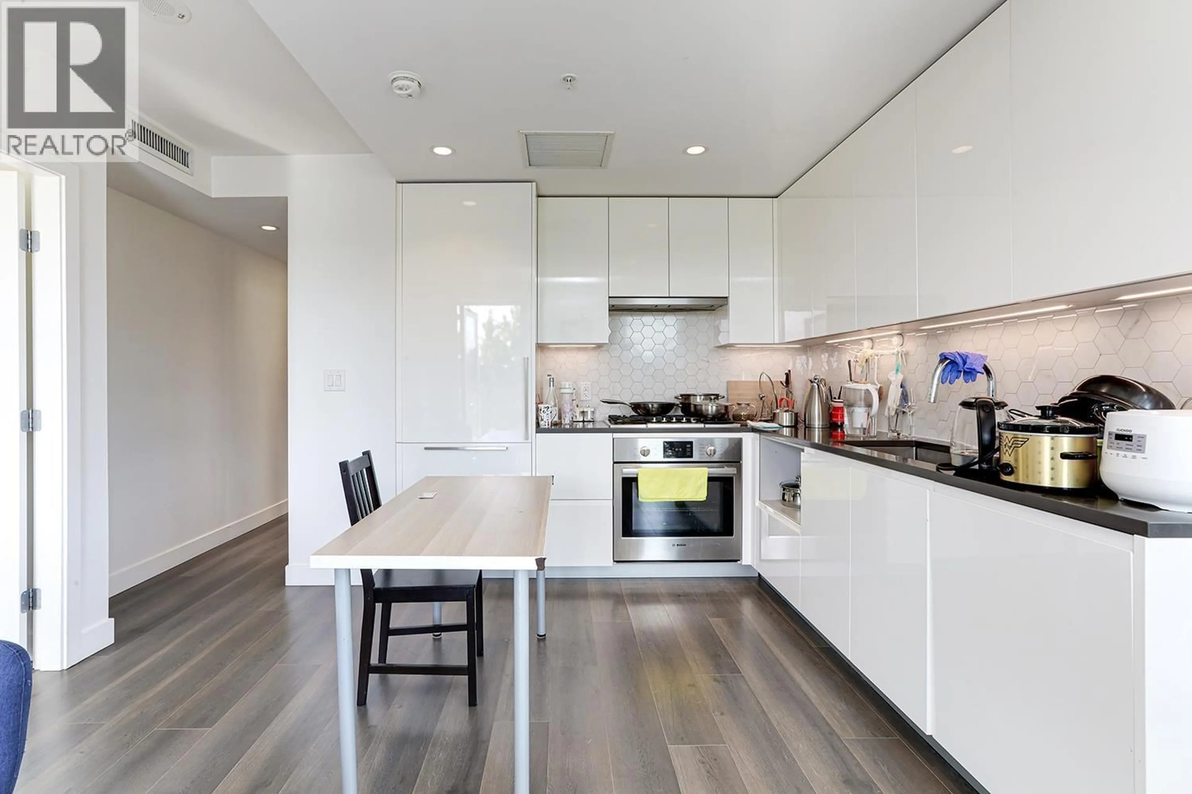Contemporary kitchen, wood/laminate floor for 403 - 8181 CHESTER STREET, Vancouver British Columbia V5X0J9