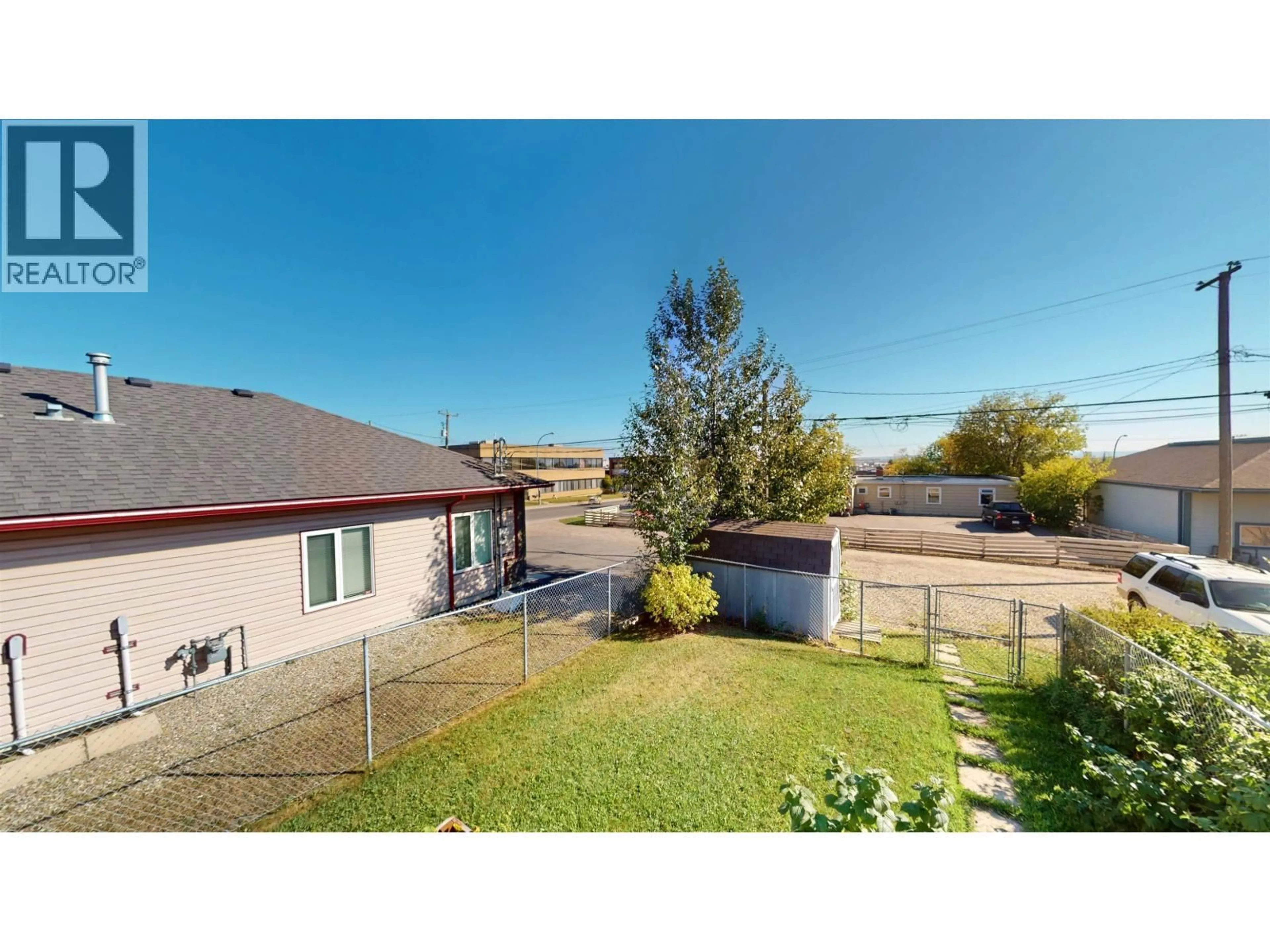 A pic from outside/outdoor area/front of a property/back of a property/a pic from drone, mountain view for 10215 102 AVENUE, Fort St. John British Columbia V1J2E4