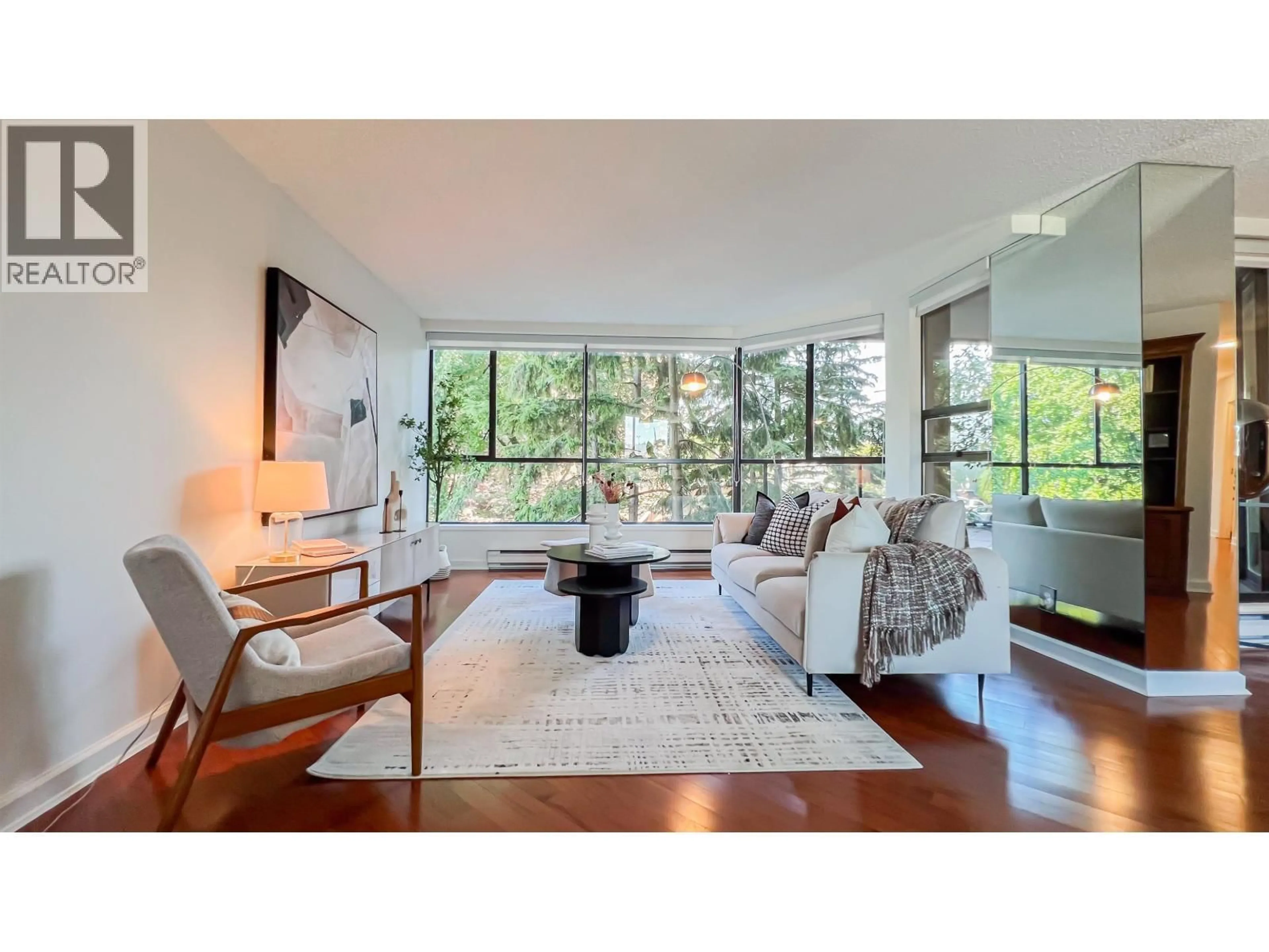 Living room with furniture, wood/laminate floor for 101 - 1450 PENNYFARTHING DRIVE, Vancouver British Columbia V6J4X8