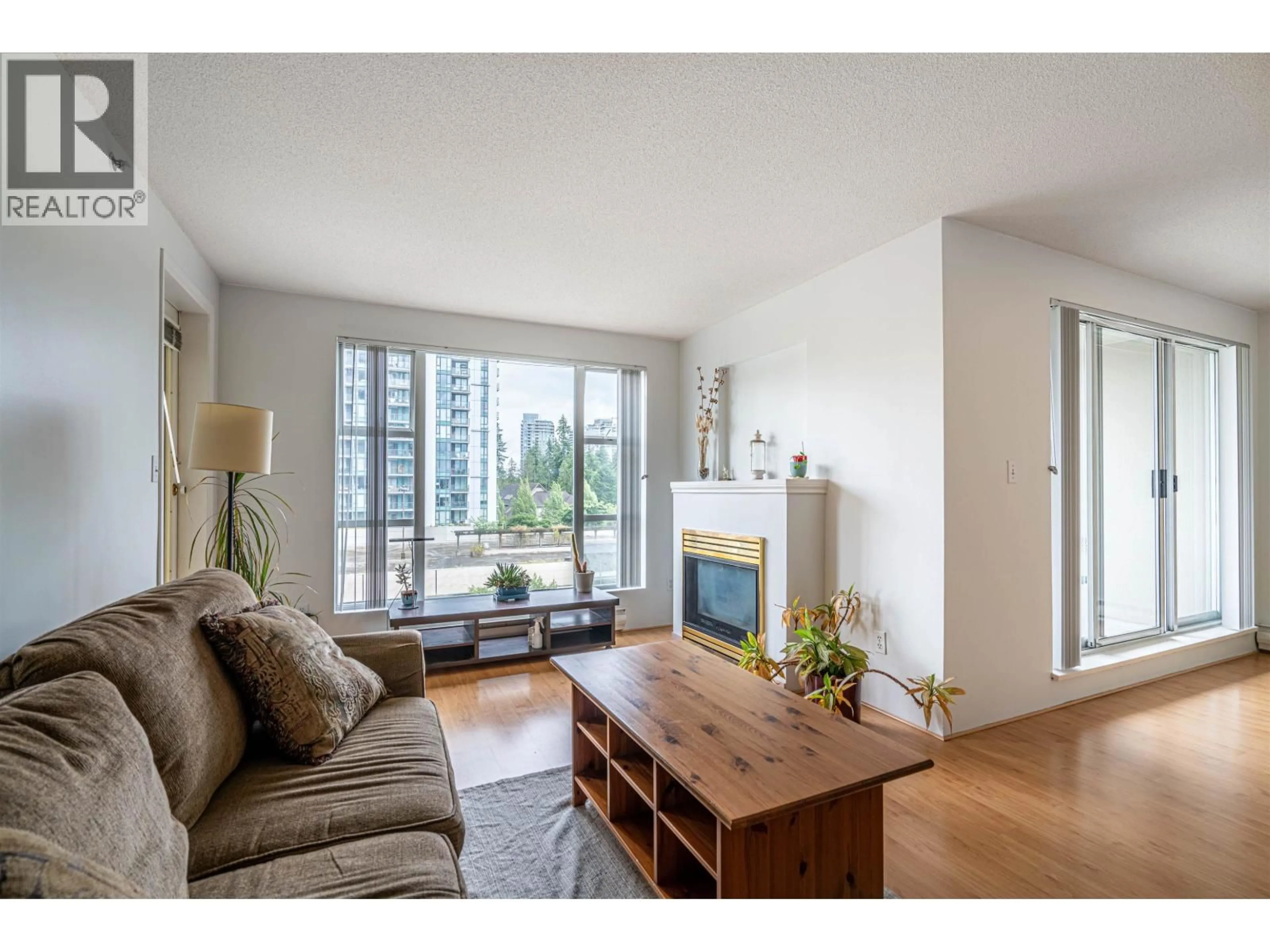 Living room with furniture, wood/laminate floor for 603 - 1180 PINETREE WAY, Coquitlam British Columbia V3B7L2