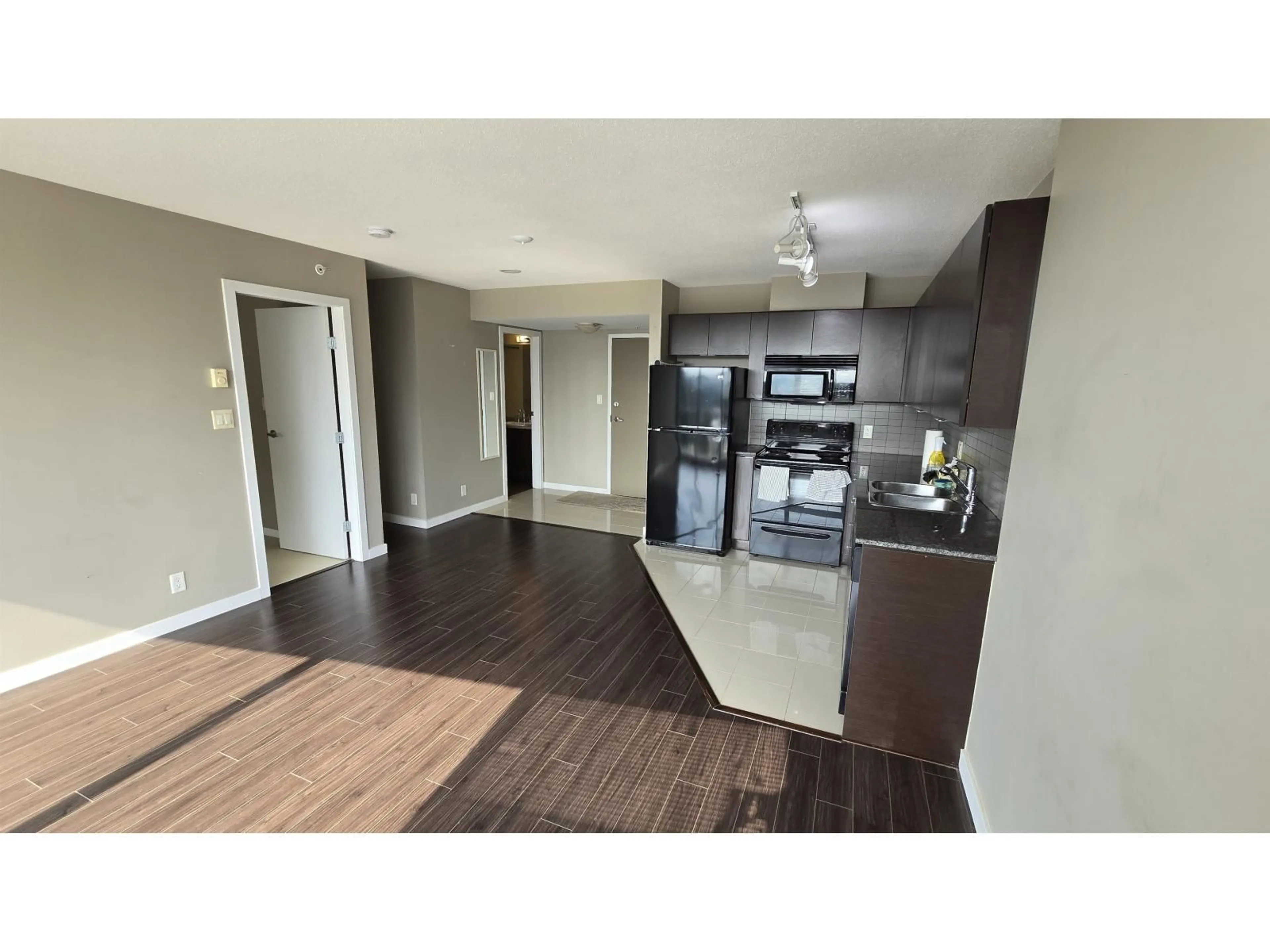 Open concept kitchen, wood/laminate floor for 1110 - 13618 100, Surrey British Columbia V3T0A8