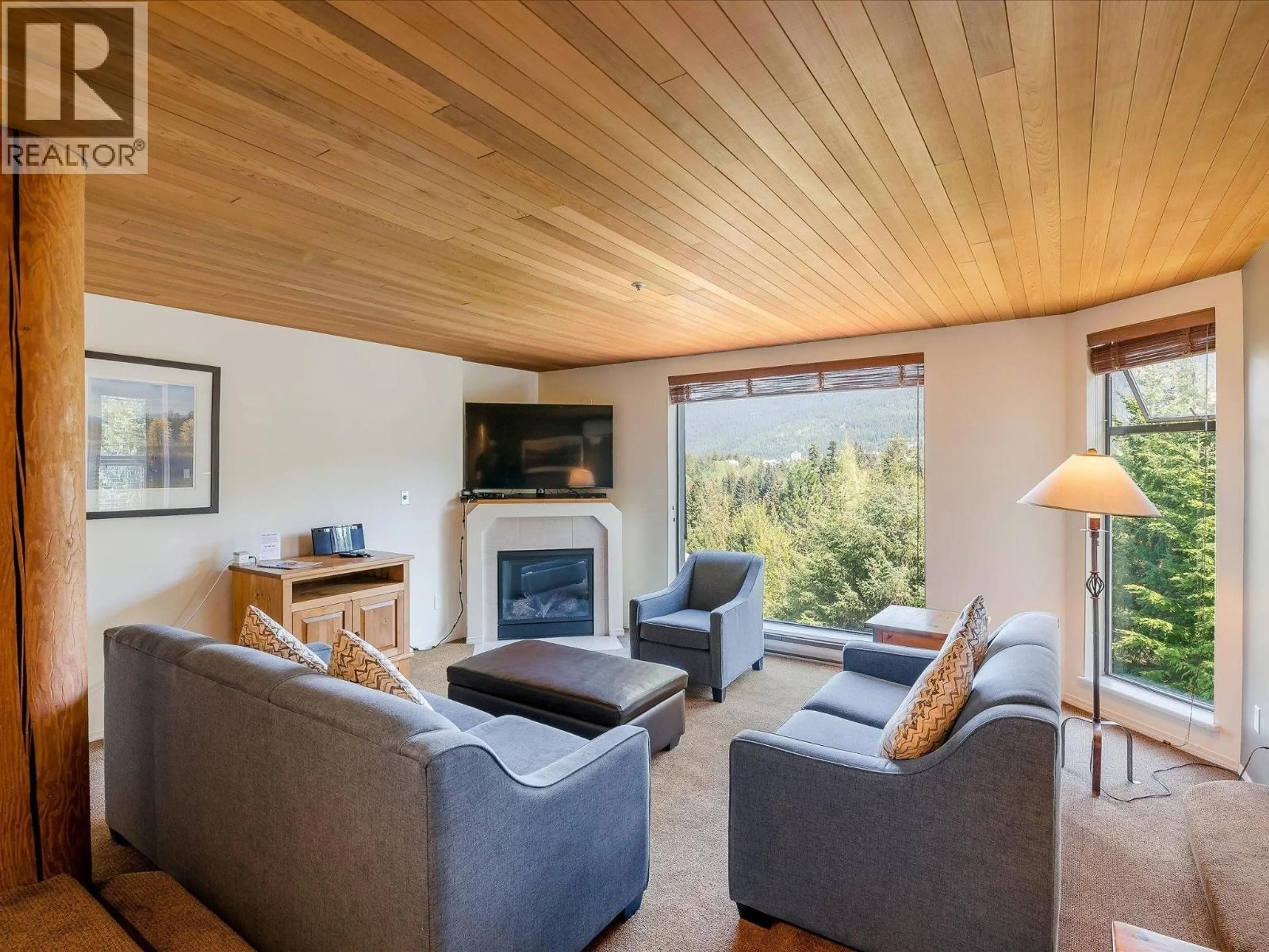Living room with furniture, wood/laminate floor for 213 - 3217 BLUEBERRY DRIVE, Whistler British Columbia V8E0B8