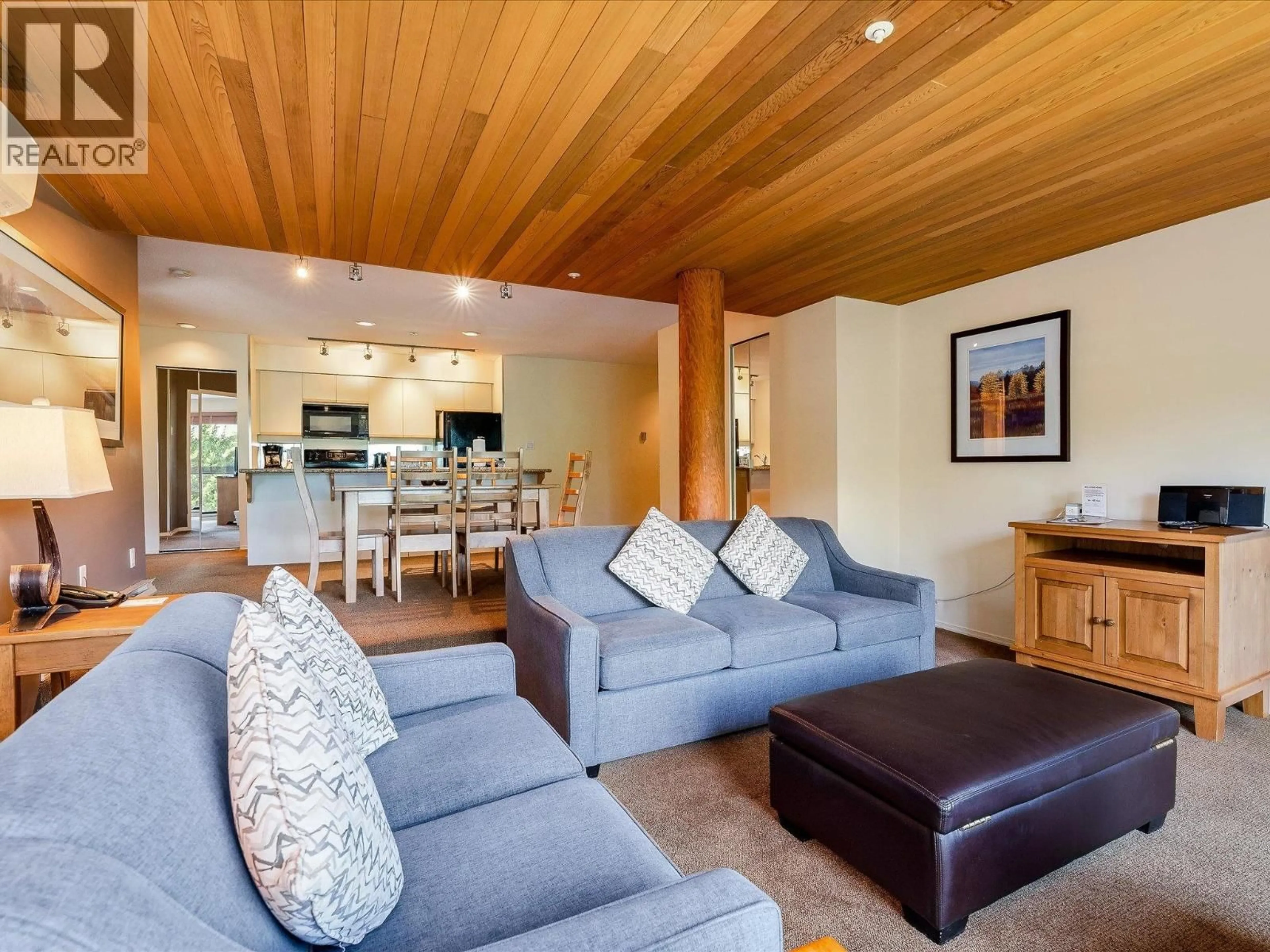 Living room with furniture, wood/laminate floor for 213 - 3217 BLUEBERRY DRIVE, Whistler British Columbia V8E0B8