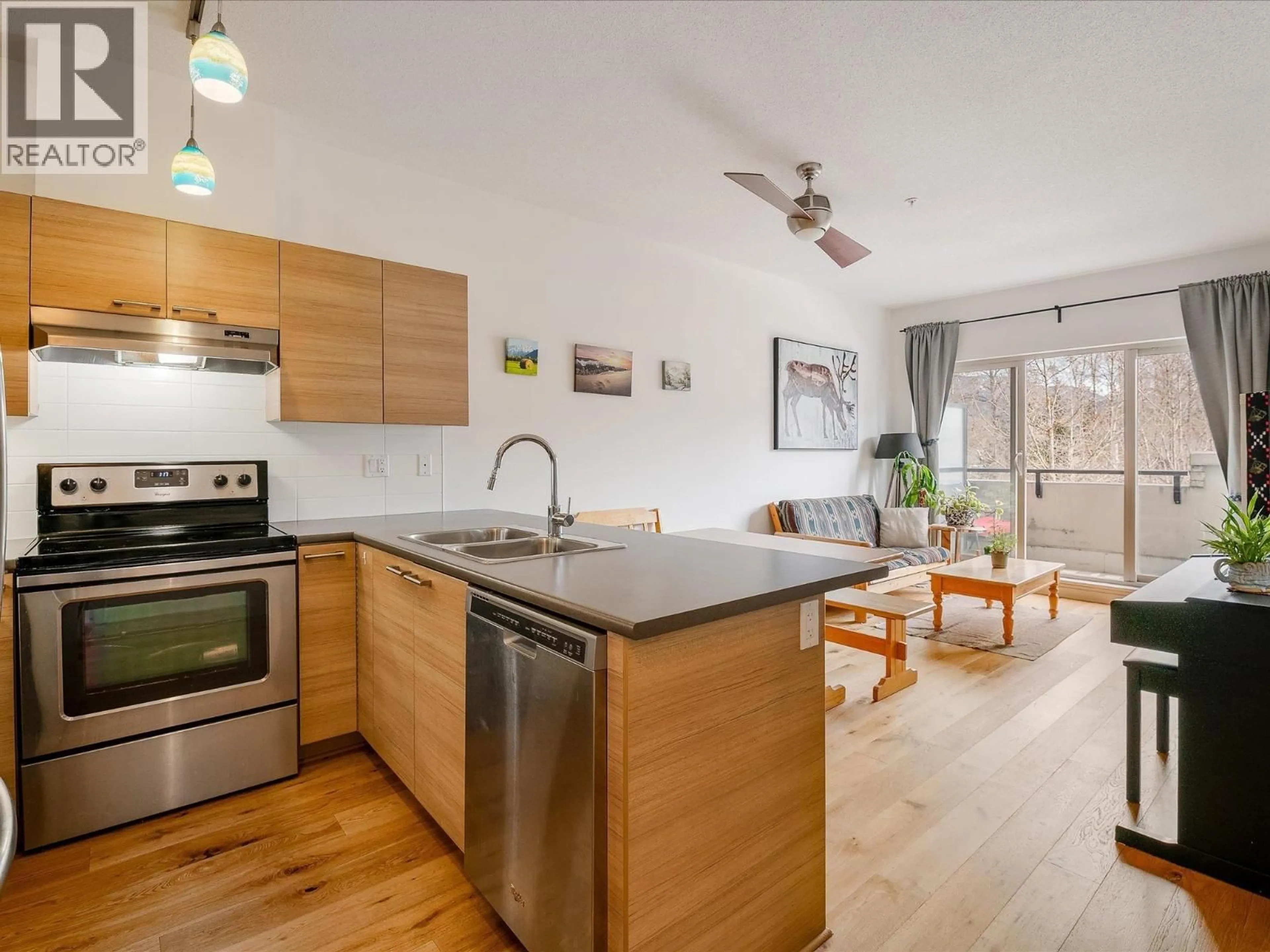 Open concept kitchen, wood/laminate floor for 208 - 7445 FRONTIER STREET, Pemberton British Columbia V0N2L1